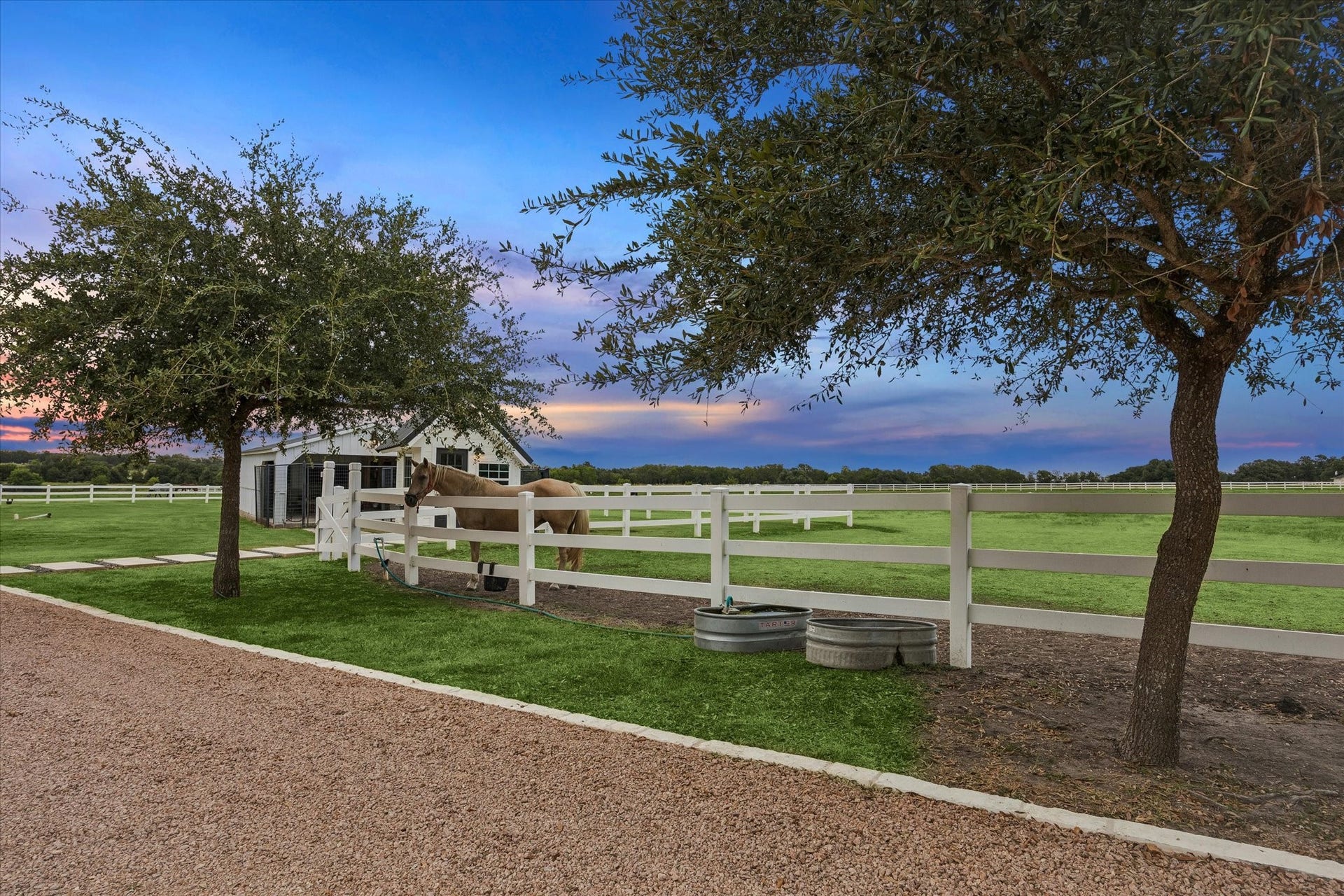 4050 Fm 2714, Round Top, TX 78954 Expansive, beautifully maintained pastures framed by mature trees and picturesque countryside views.