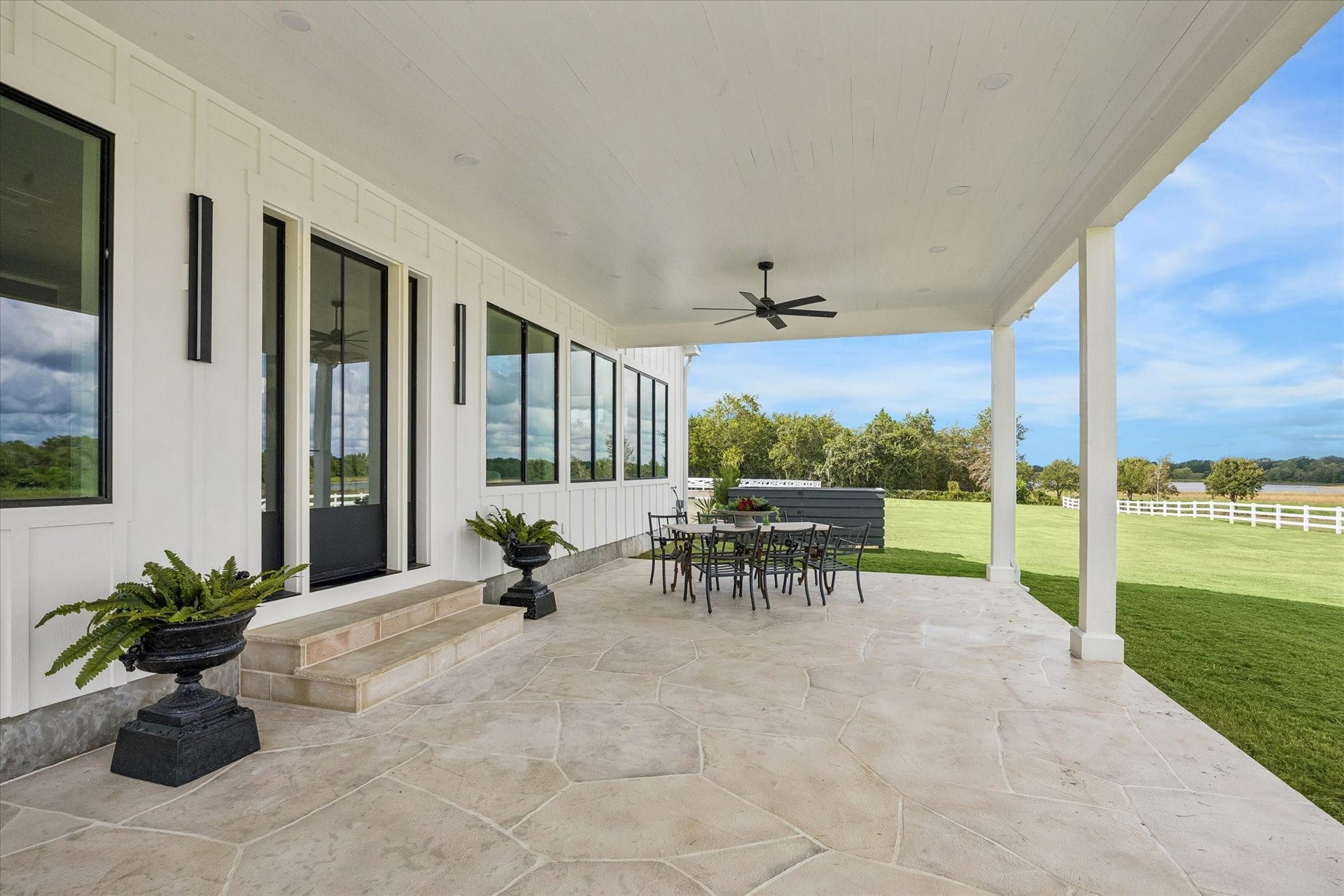 4050 Fm 2714, Round Top, TX 78954 Inviting front porch creates a gracious welcome, offering a charming introduction to this exceptional country property.