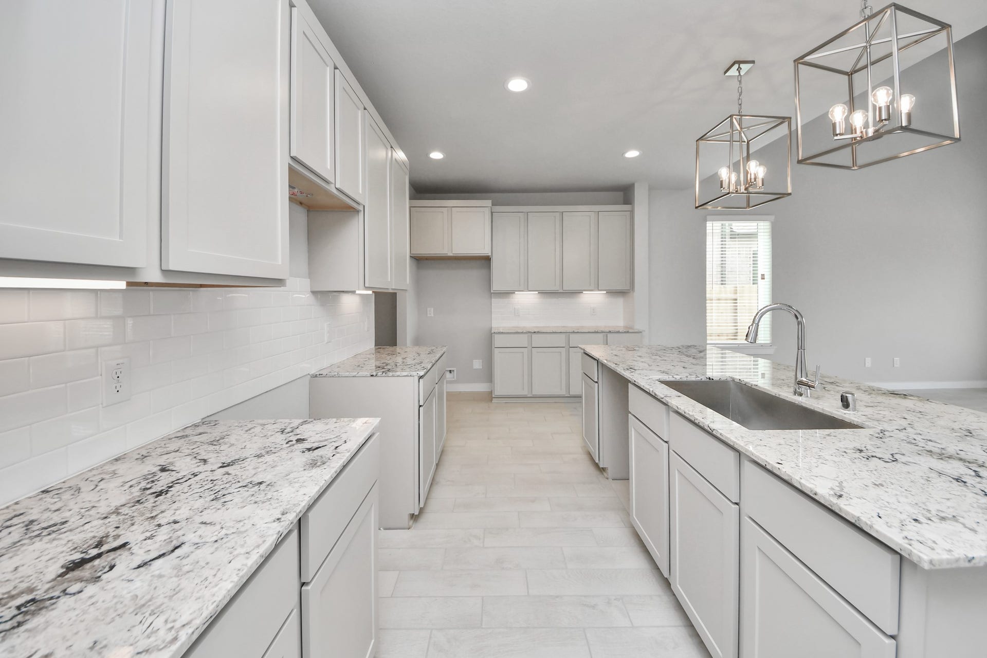 11115 Tulip Ridge Trail, Houston, TX 77044 The kitchen is a culinary haven, featuring granite countertops, a tile backsplash, stainless steel appliances, 42 upper cabinets, and undercabinet lighting. Sample photo of completed home with similar floor plan. Actual colors and selections may vary.