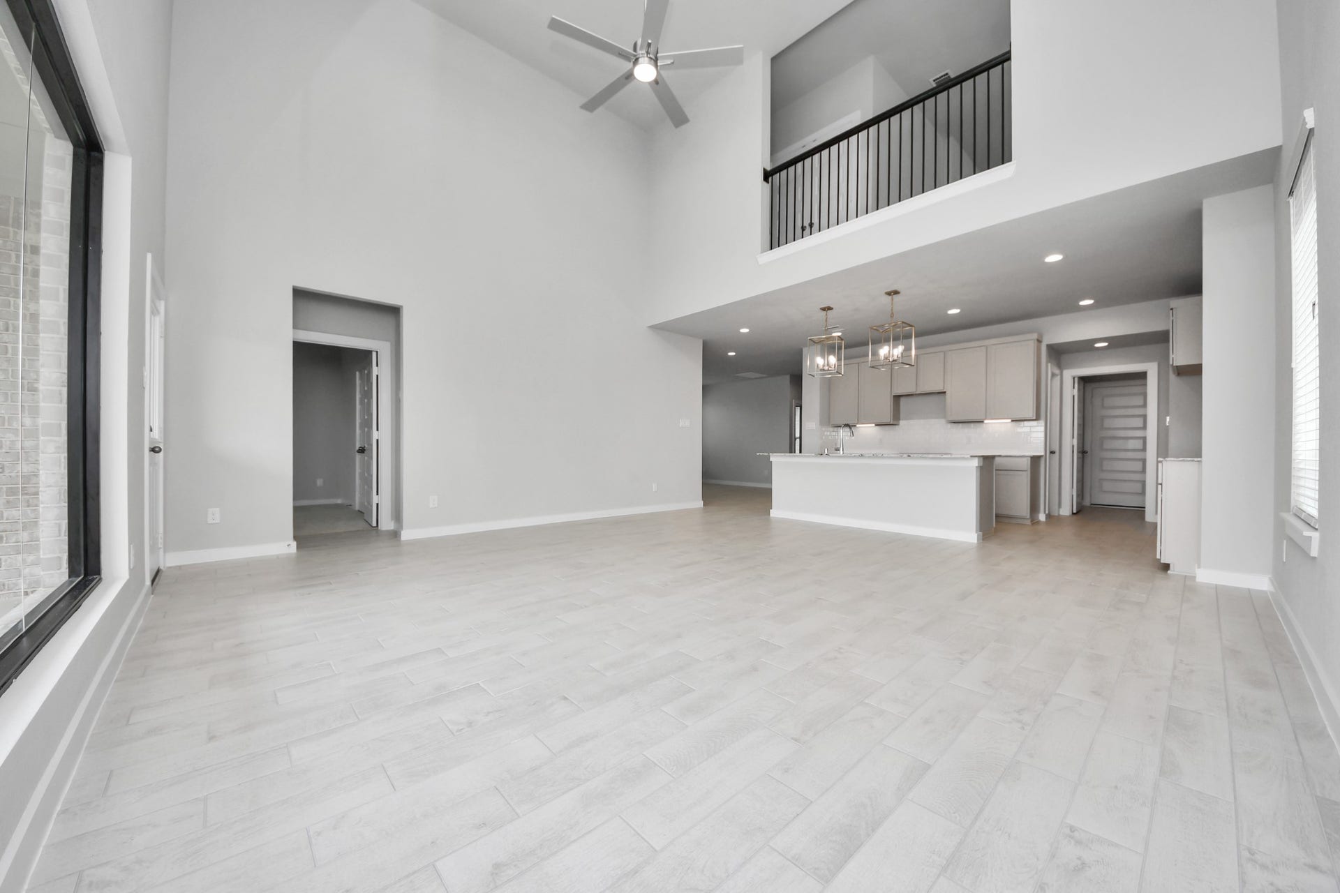 11115 Tulip Ridge Trail, Houston, TX 77044 Relax and unwind in this inviting family room, illuminated by abundant natural light streaming in through tall windows, complemented by high ceilings and stunning flooring. Stay comfortable year-round with the gentle breeze from the ceiling fan, creating the perfect atmosphere for family gatherings. Sample photo of completed home with similar floor plan. Actual colors and selections may vary.