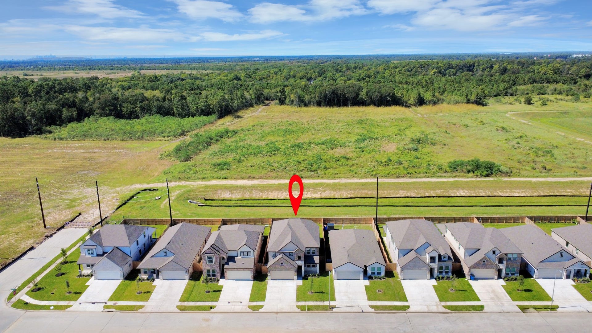 11115 Tulip Ridge Trail, Houston, TX 77044 An aerial view of a spacious subdivision lot, highlighting a well-maintained yard and a fully fenced perimeter, offering both privacy and expansive outdoor space.