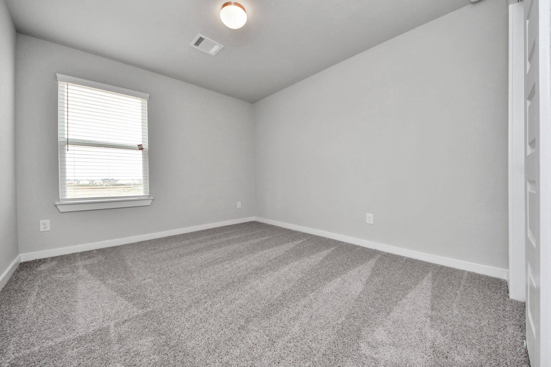 11115 Tulip Ridge Trail, Houston, TX 77044 Generously sized secondary bedrooms featuring spacious closets, soft and inviting carpeting underfoot, large windows allowing plenty of natural light, and the added touch of privacy blinds for your personal retreat. Sample photo of completed home with similar floor plan. Actual colors and selections may vary.