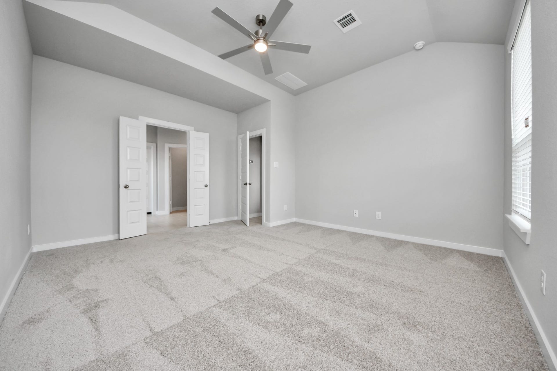 11115 Tulip Ridge Trail, Houston, TX 77044 Come and unwind after a long day in this magnificent primary suite! This spacious room features plush carpet, warm paint, high ceilings and large windows with privacy blinds. Sample photo of completed home with similar floor plan. Actual colors and selections may vary.