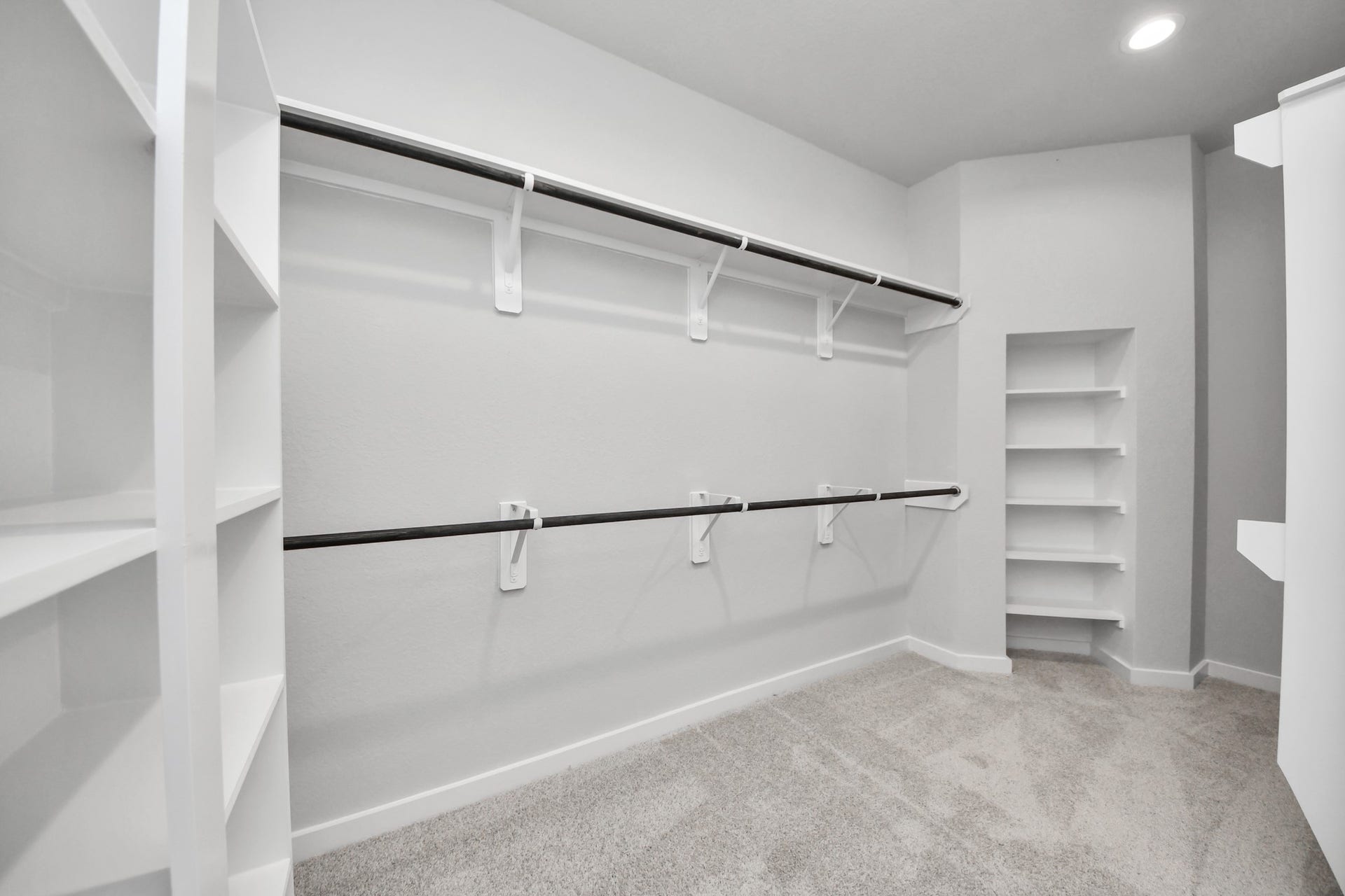 11115 Tulip Ridge Trail, Houston, TX 77044 Walk-in closet that epitomizes luxury and practicality. This generously sized space features built-in shelving, offering abundant room for impeccable organization. High ceilings and recessed lighting create a bright and welcoming ambiance. Sample photo of completed home with similar floor plan. Actual colors and selections may vary.
