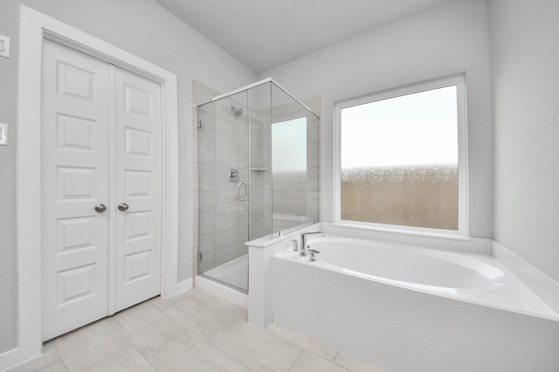 11115 Tulip Ridge Trail, Houston, TX 77044 Indulge in a spa-like retreat within the confines of this primary bathroom. Delight in a spacious walk-in shower enveloped in stylish tile surround, unwind in a separate garden tub adorned with custom detailing. Sample photo of completed home with similar floor plan. Actual colors and selections may vary.