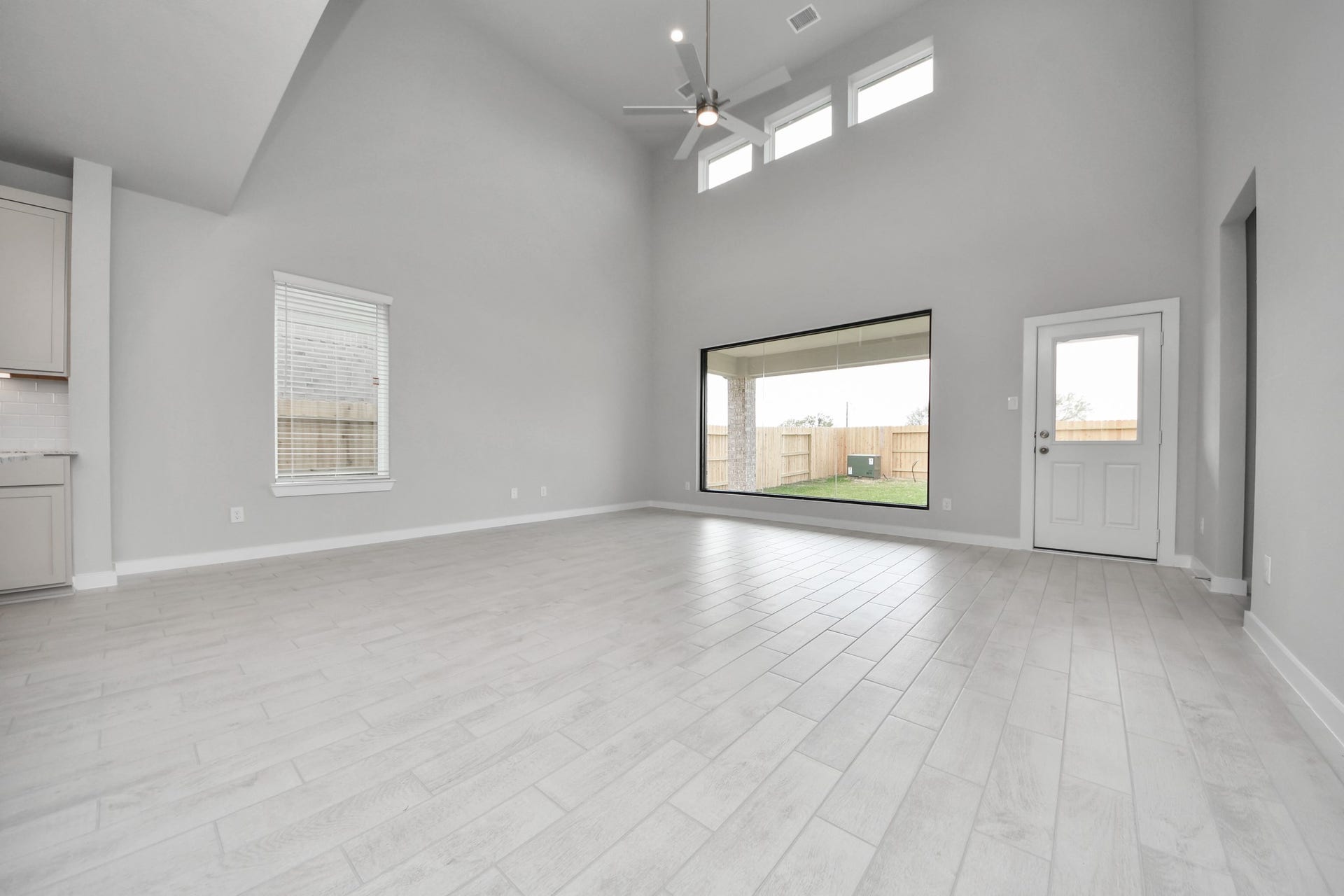 11115 Tulip Ridge Trail, Houston, TX 77044 Welcome family and guests to your charming living room! With its high ceilings, recessed lighting, ceiling fan, custom paint, beautiful flooring, and large windows that let in abundant natural light, this room is perfect for gatherings. Sample photo of completed home with similar floor plan. Actual colors and selections may vary.