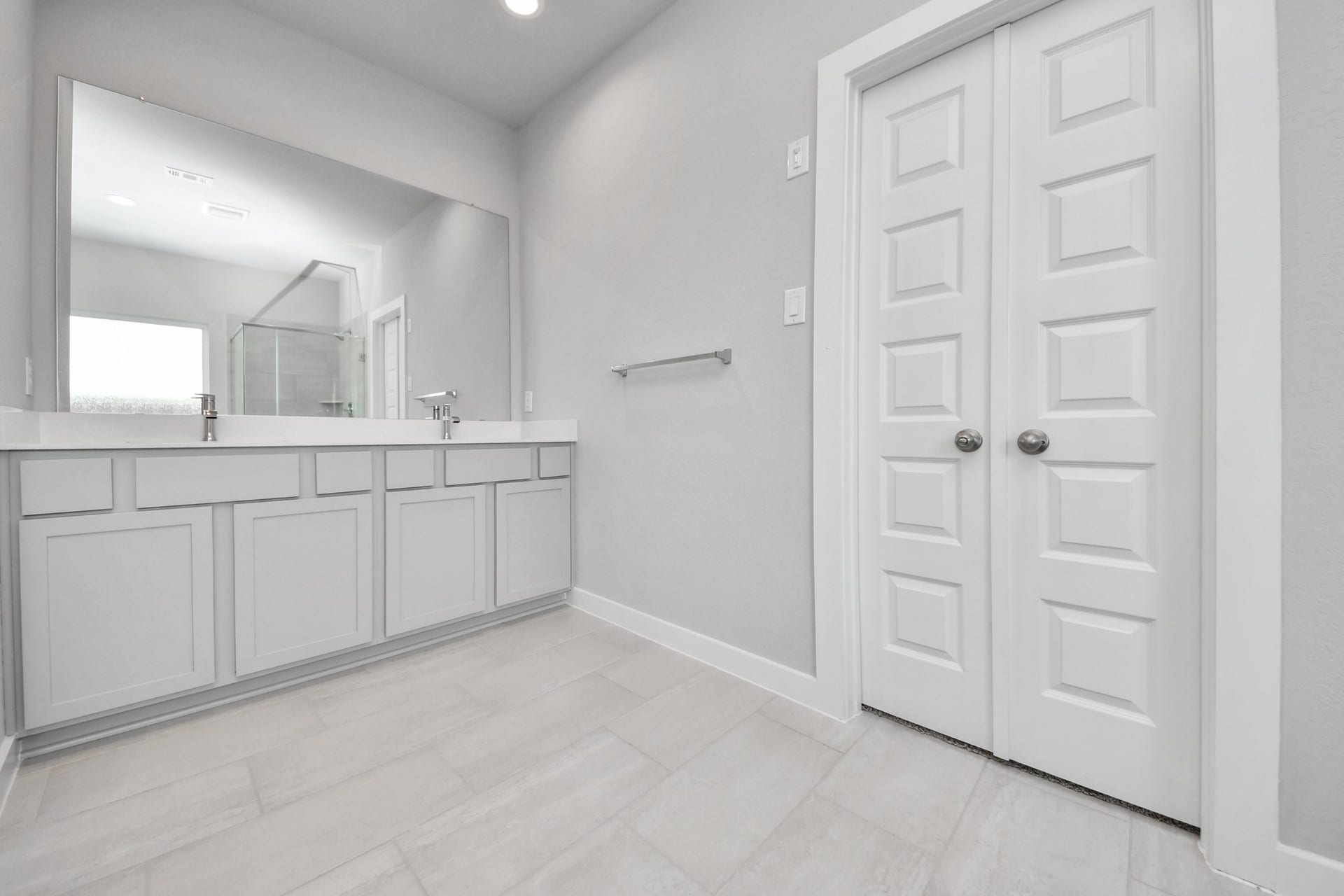 11115 Tulip Ridge Trail, Houston, TX 77044 Elevate your daily routine at the elegant vanity, now equipped with double sinks, light countertops, modern hardware, and beautiful recessed lights. Sample photo of completed home with similar floor plan. Actual colors and selections may vary.