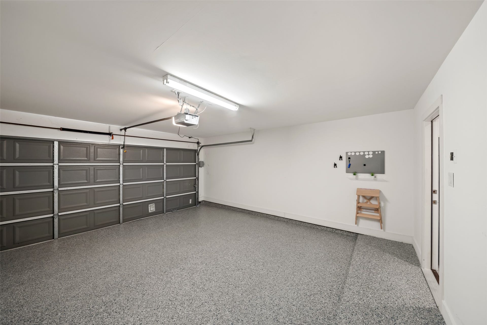 258 Sentry Maple Place, The Woodlands, TX 77382 The spacious two car garage offers a clean interior with epoxied floors and ample storage potential.