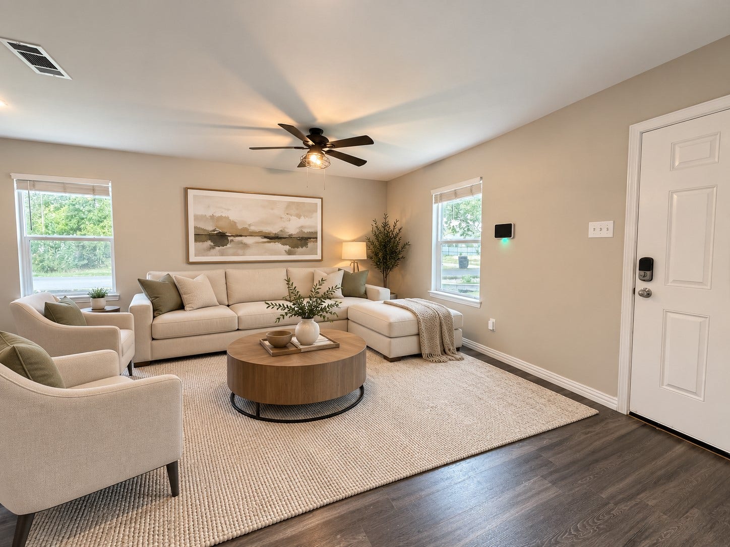 The living area has plenty of natural light designed for comfortable everyday living and entertaining. This photo is virtually staged.