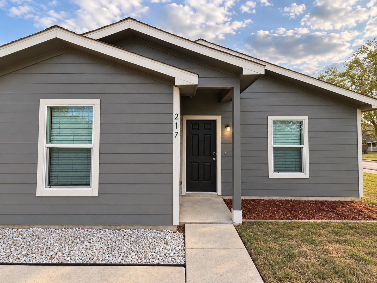 A closer look at the entrance offering a clean modern exterior and inviting covered entry.