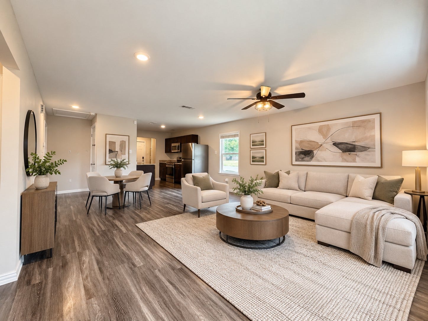 As you enter, you are greeted with a generous living area with natural light and an open connection to the dining space and kitchen. This photo is virtually staged.