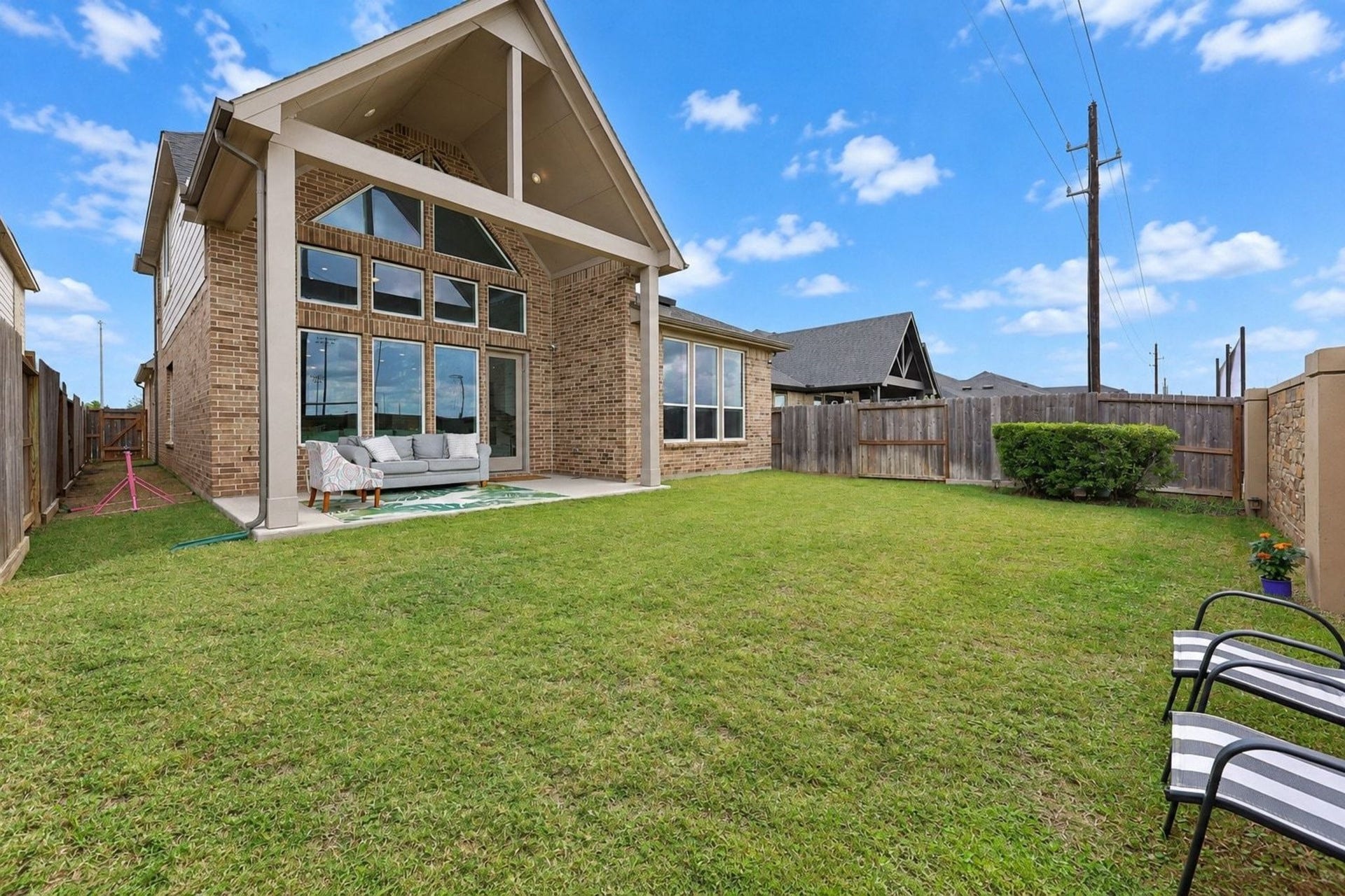 29651 Bur Creek Lane, Fulshear, TX 77441 Discover the perfect outdoor retreat with a spacious backyard featuring a covered patio, stylish brick exterior, and ample room for relaxation and entertainment.