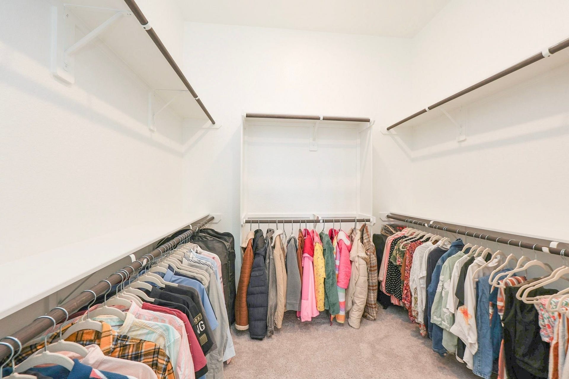29651 Bur Creek Lane, Fulshear, TX 77441 Spacious primary walk-in closet with ample hanging space and shelving, perfect for organized storage.