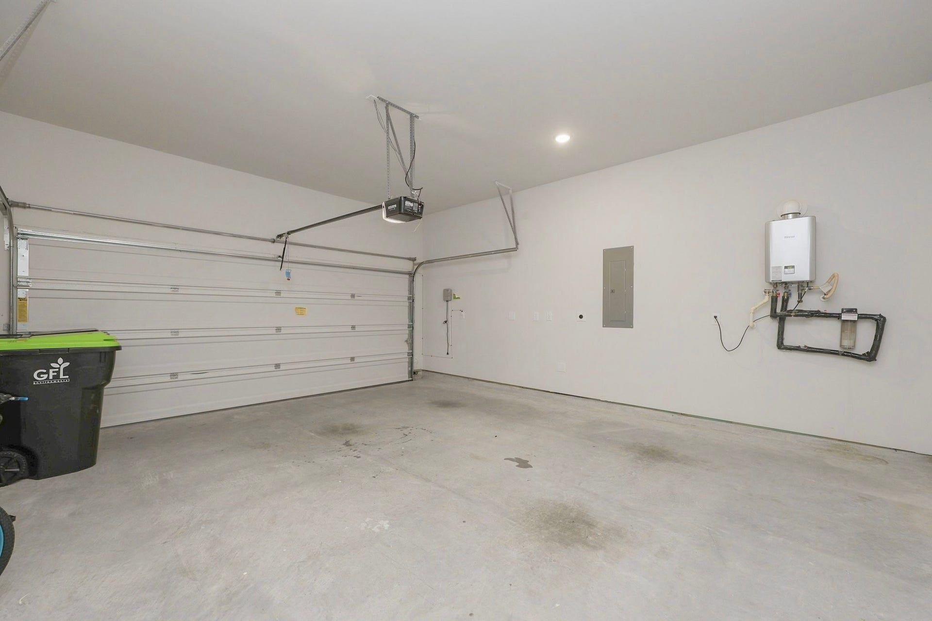 29651 Bur Creek Lane, Fulshear, TX 77441 Spacious two-car garage featuring a modern tankless water heater and ample room for storage and the control of the sprinkler system is in the garage. Garage also has an EV charging Socket.