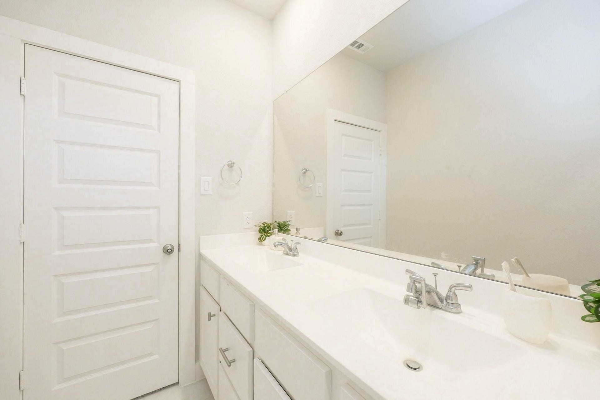 29651 Bur Creek Lane, Fulshear, TX 77441 Bright and modern bathroom on 2nd floor featuring a double vanity with sleek fixtures, ample storage, and a large mirror enhancing the sense of space.