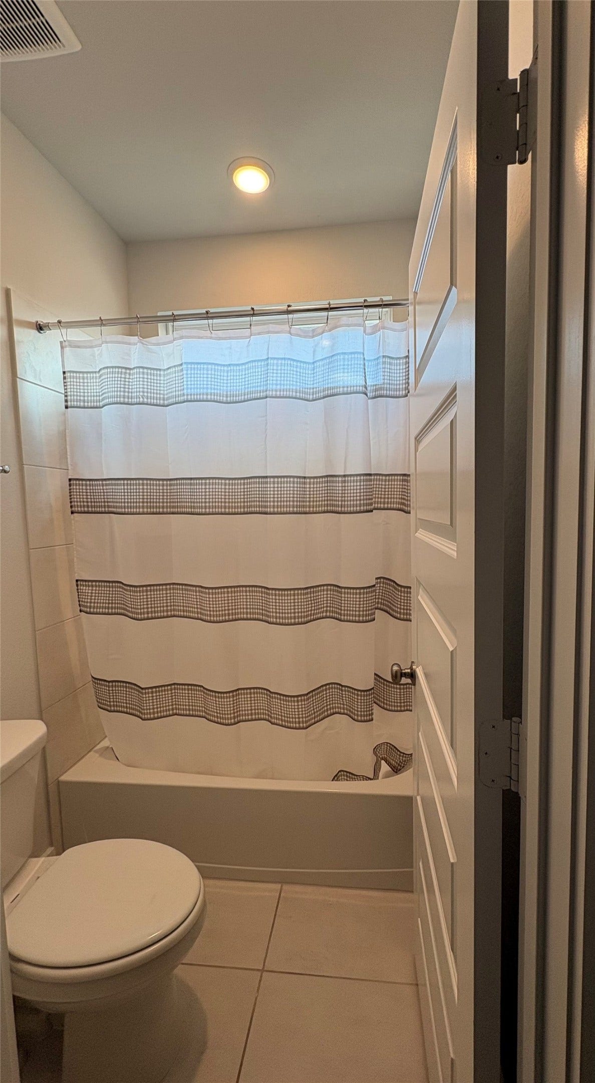 29651 Bur Creek Lane, Fulshear, TX 77441 View of the secondary bathroom on 2nd floor. Equipped with double vanity and a tub and shower and window on top of tub.
