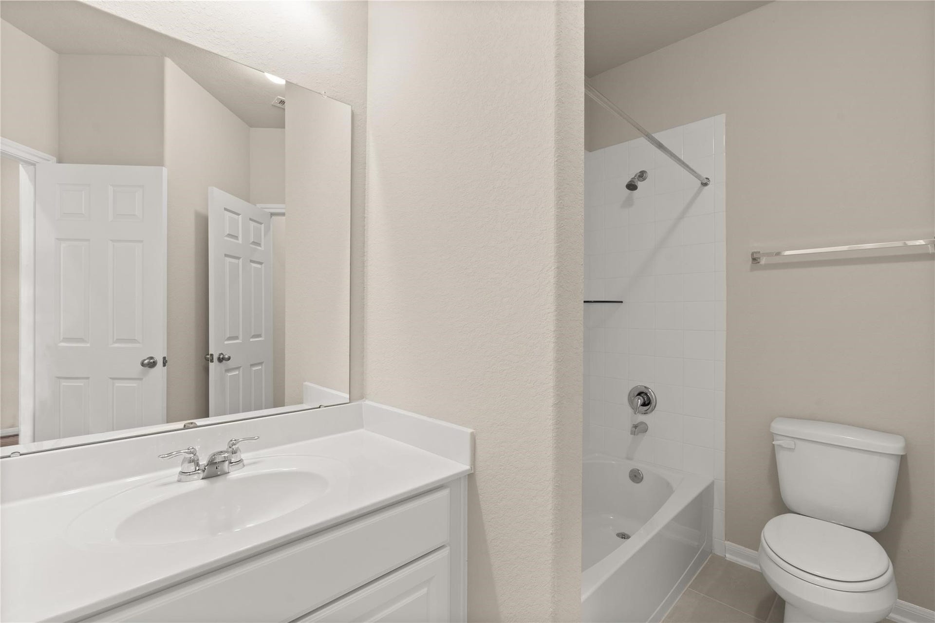 2459 Solaris Bend Drive, Katy, TX 77493 The secondary bath features tile flooring, white cabinetry and light countertops with a shower-tub combo. Perfect for accommodating any visiting family and friends.