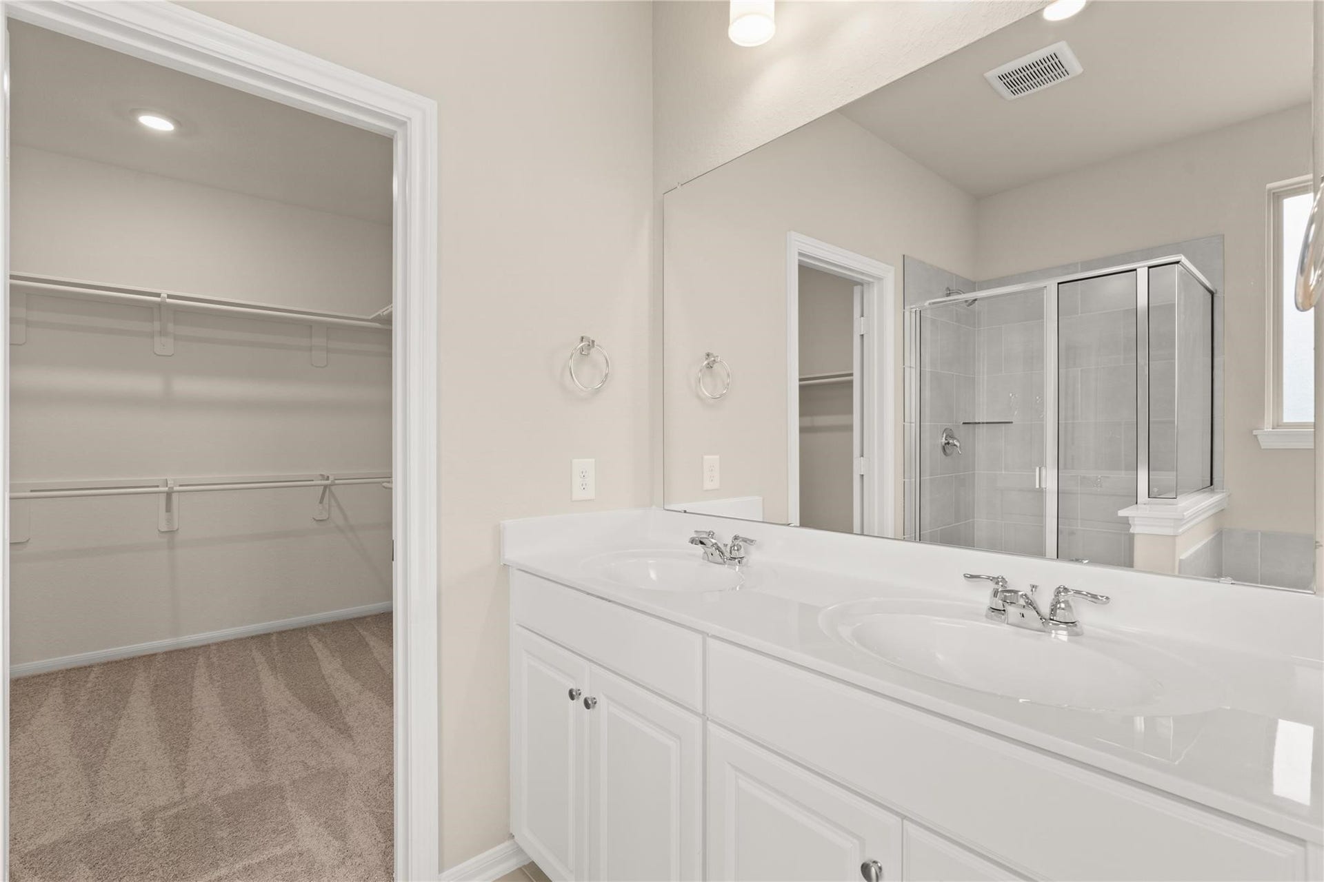 2459 Solaris Bend Drive, Katy, TX 77493 The en-suite primary bathroom offers a spa-like atmosphere with its elegant design, high end finishes, and tasteful lighting, creating a retreat within your own home.