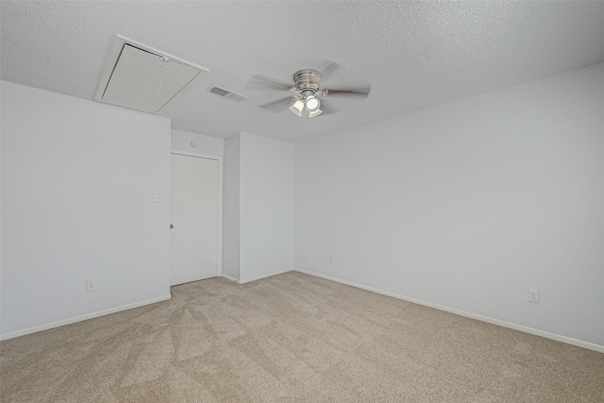 Upstairs bedroom with ceiling fans