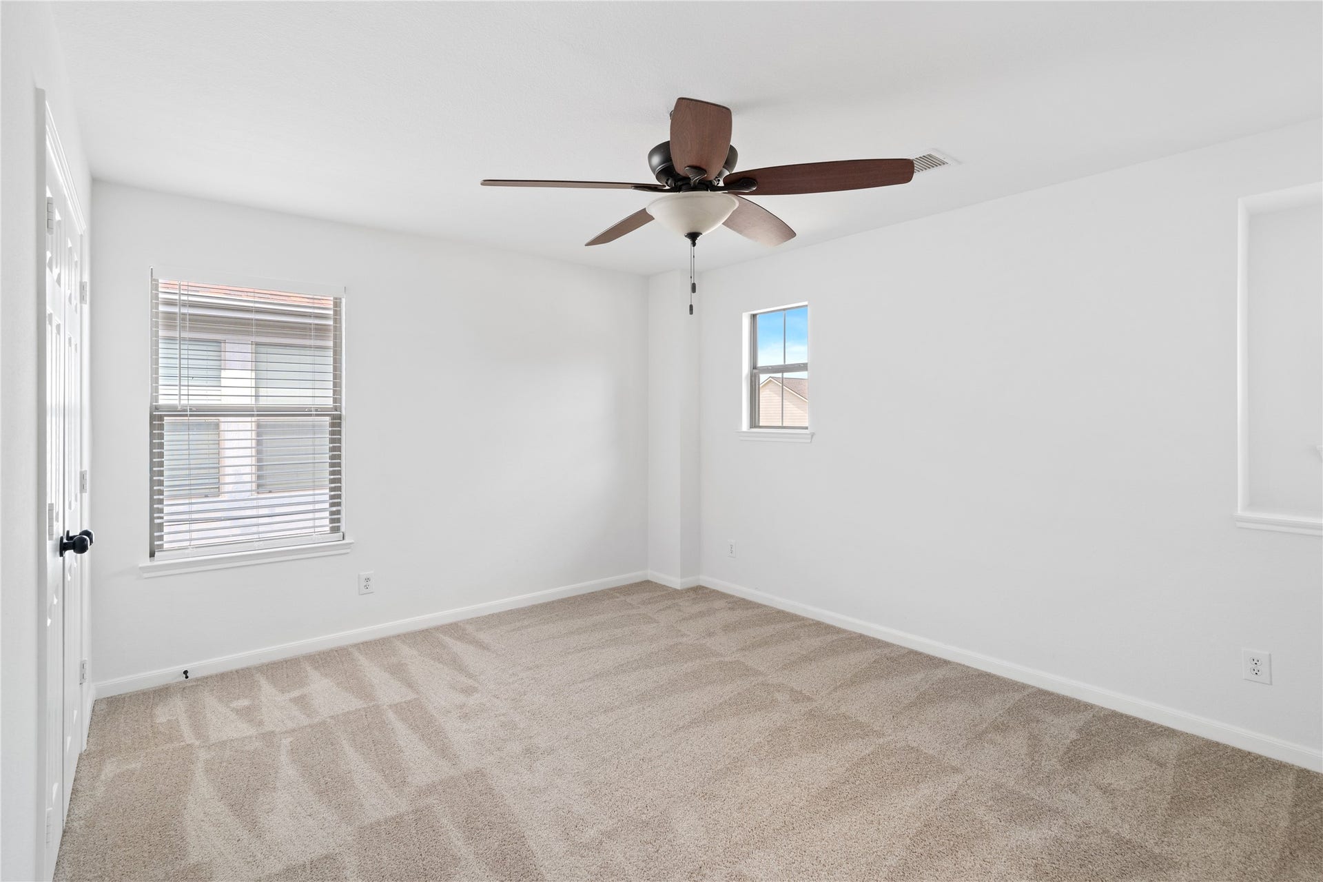 21611 Manitou Falls Lane, Katy, TX 77449 Bedroom Bright secondary bedroom featuring neutral carpet, a ceiling fan, and multiple windows for natural light.
