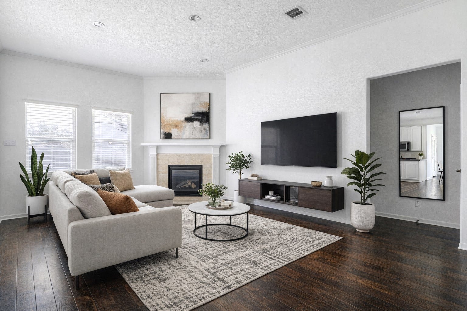 AI Staged photo of modern living
room featuring a gas fireplace
(includes remote) and beautiful
dark hardwood floors (upgrade).