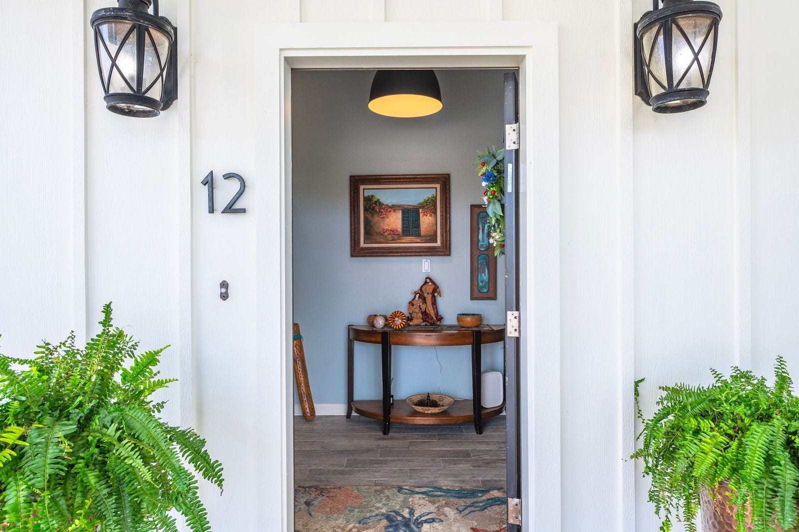 12 Tiki Circle, Tiki Island, TX 77554 Easy Coastal-Style Living! Inviting entrance featuring exterior coach lighting.
