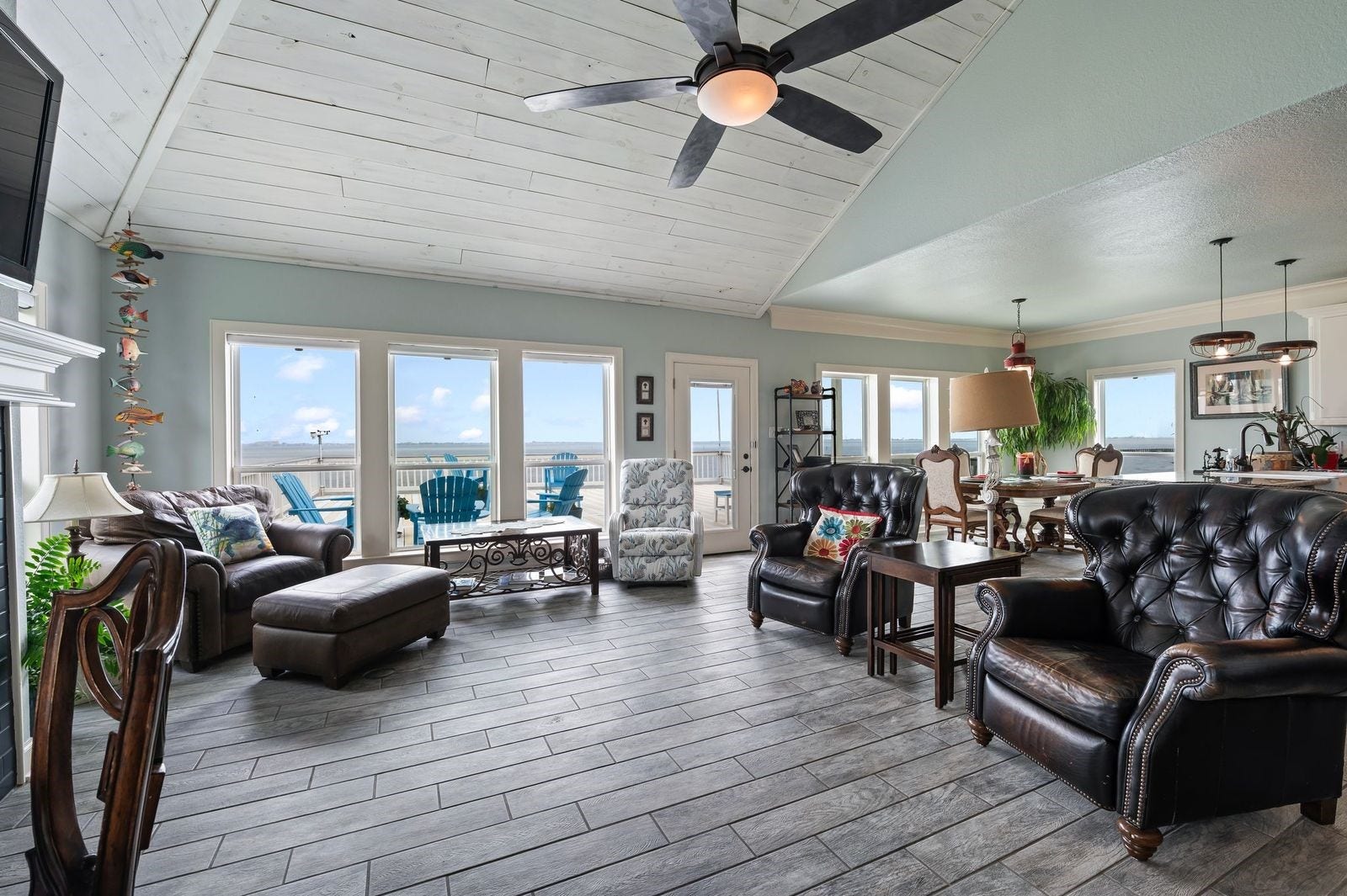 12 Tiki Circle, Tiki Island, TX 77554 Character Filled Residence with Breathtaking Views and Wall-of-Windows! Ceramic tile flooring and custom cedar plank soaring ceiling.