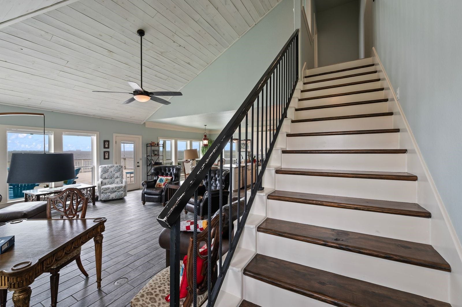 12 Tiki Circle, Tiki Island, TX 77554 Comfortable, Quiet, Luxury! Staircase leading to 2nd level features solid wood flooring and wrought iron railing.