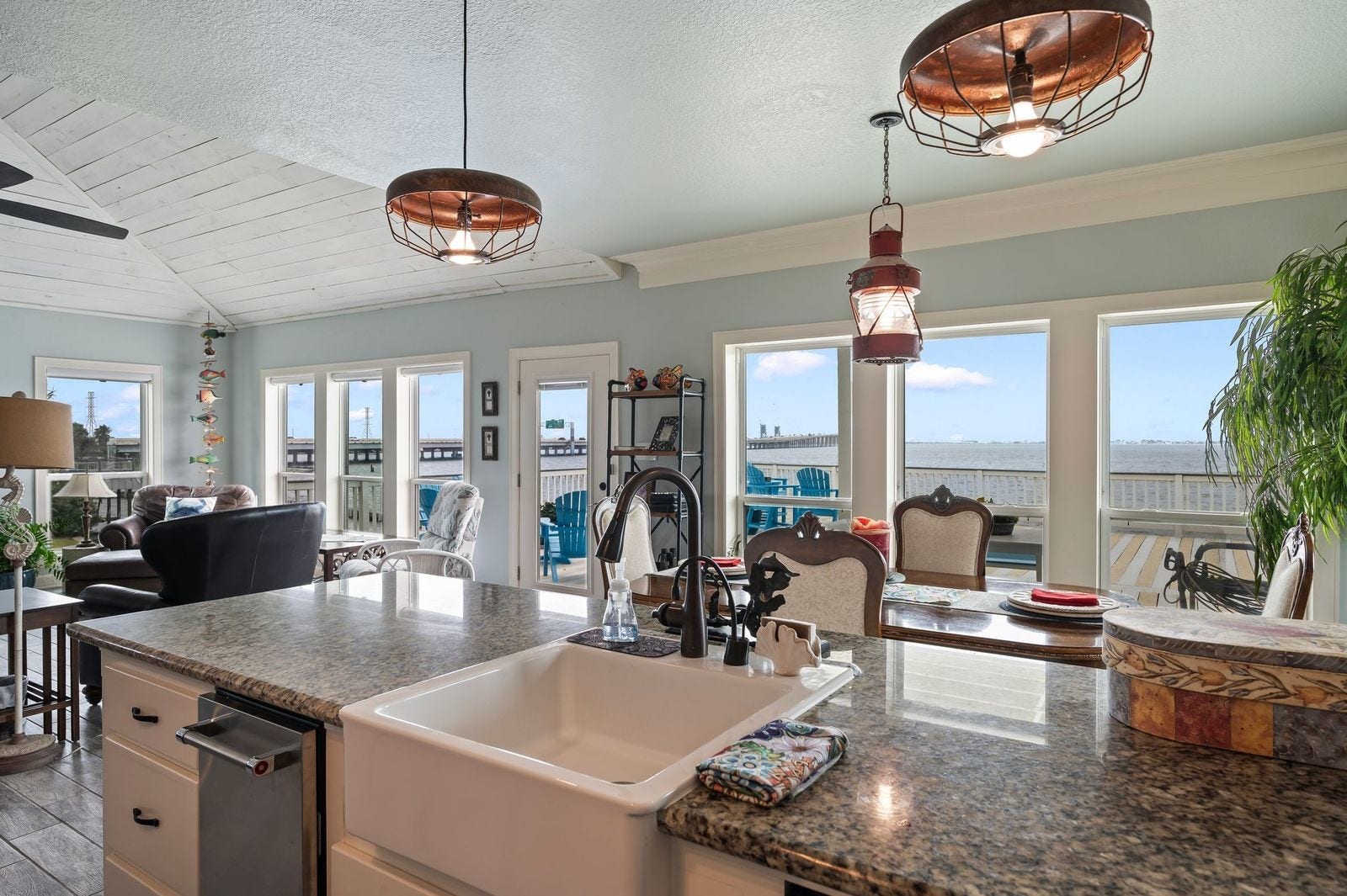 12 Tiki Circle, Tiki Island, TX 77554 Sophisticated & Modern with Unlimited Water Views! Granite counter tops with large farmer's sink and custom coastal light fixtures.