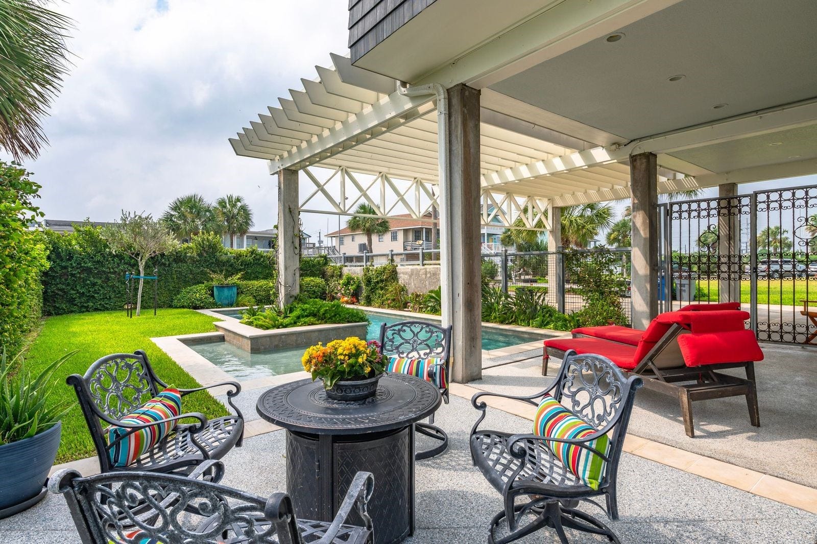 12 Tiki Circle, Tiki Island, TX 77554 The Lifestyle You Have Dreamed About! Fully fenced private yard with swimming pool, wrought gate and extended patio space.