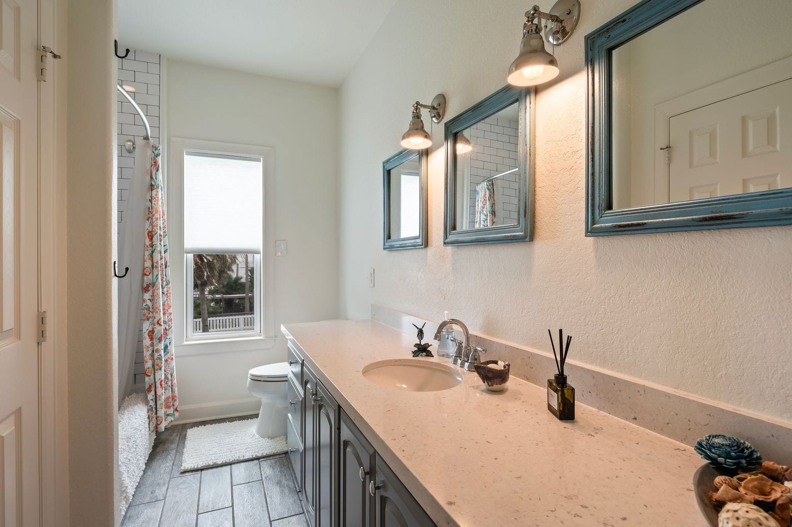 12 Tiki Circle, Tiki Island, TX 77554 Detailed view of the spacious secondary bathroom featuring undermount sink, linen storage and custom fixtures.