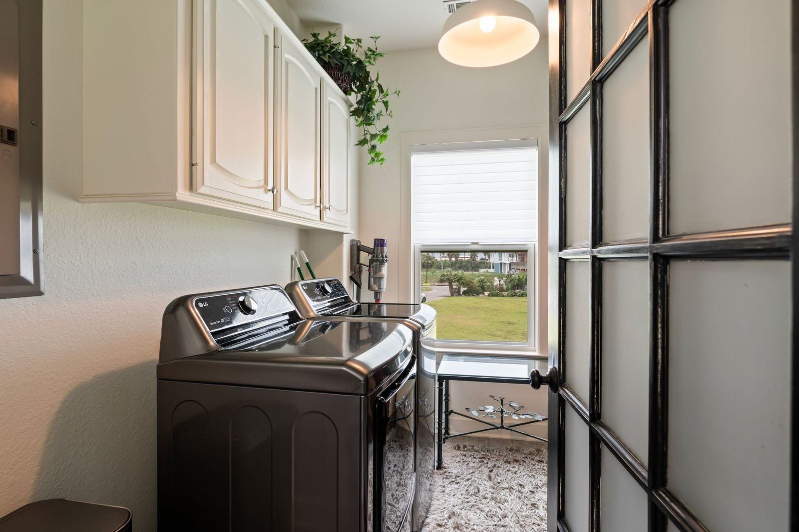 12 Tiki Circle, Tiki Island, TX 77554 Space & Style! Large laundry room with storage cabinets.