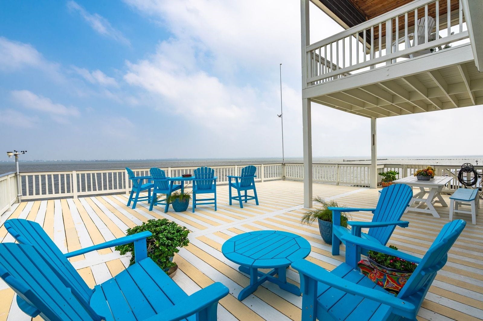 12 Tiki Circle, Tiki Island, TX 77554 Designed with entertaining in mind, the extended outdoor patio and upper deck provide breathtaking views of Galveston Bay.
