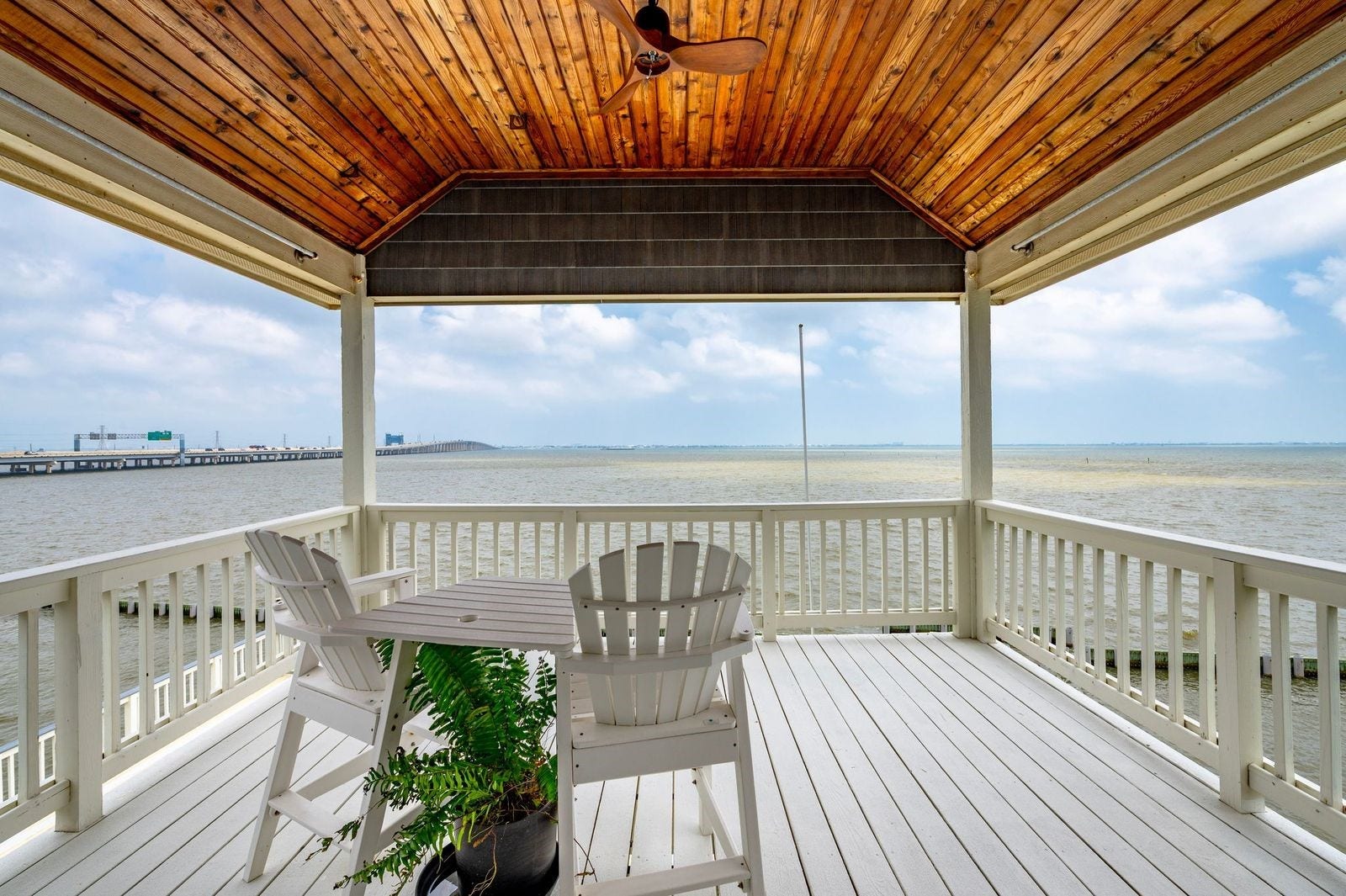 12 Tiki Circle, Tiki Island, TX 77554 Views, Versatility and Value! Priceless views off the upper deck located off the primary bedroom featuring cedar plank accented ceiling and ceiling fan.