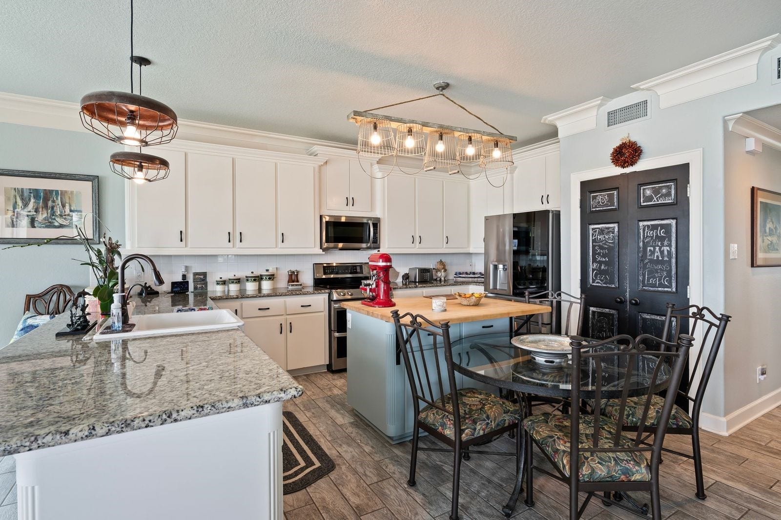 12 Tiki Circle, Tiki Island, TX 77554 Spectacular, Stylish And Spacious! Ample kitchen cabinet storage with stainless steel appliances with double oven, overhead microwave and dishwasher.