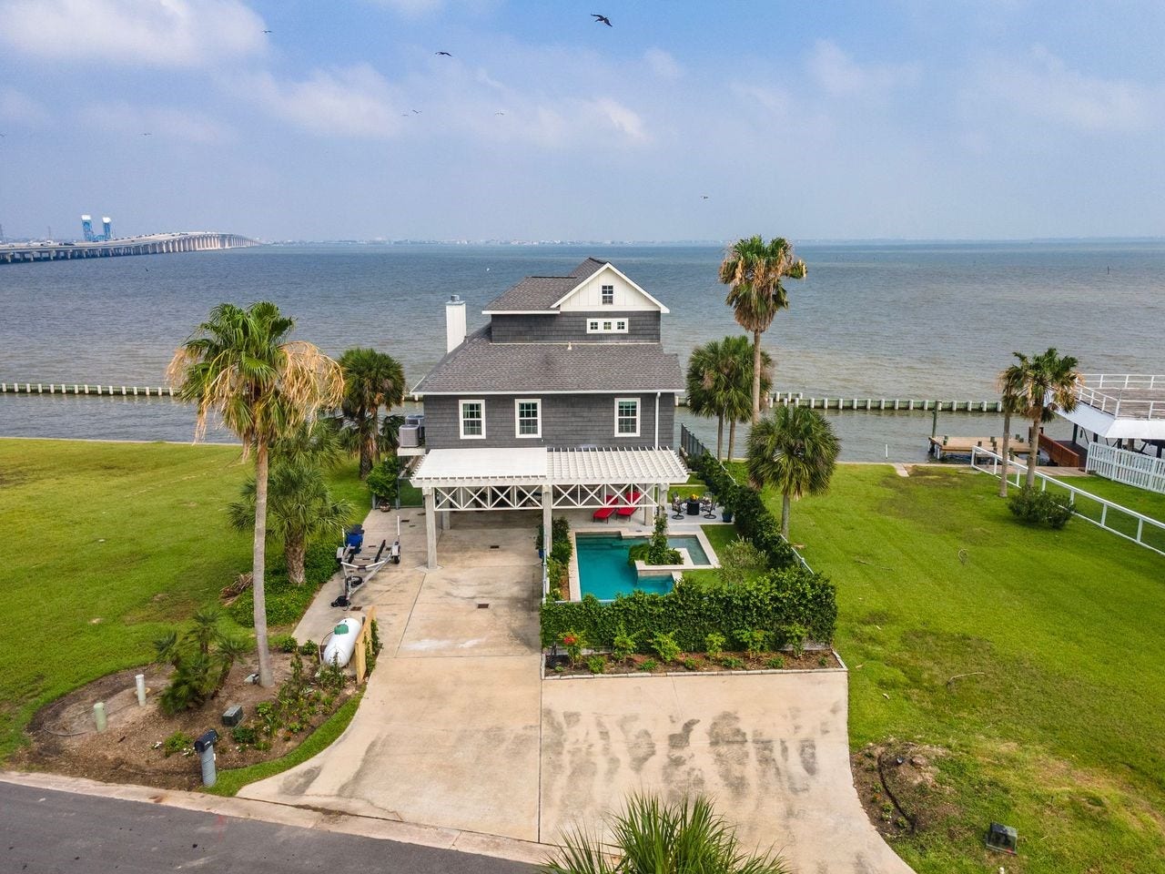 12 Tiki Circle, Tiki Island, TX 77554 An Iconic Waterfront Location!