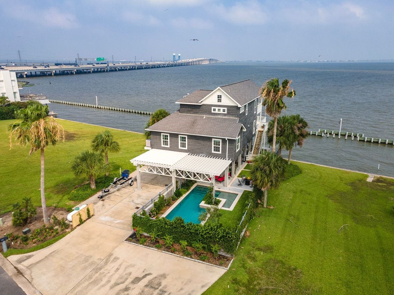 12 Tiki Circle, Tiki Island, TX 77554 Ideally positioned in one of Tiki Island's most sought-after waterfront locations! Enjoy unparalleled privacy with no immediate neighbors on either side.
