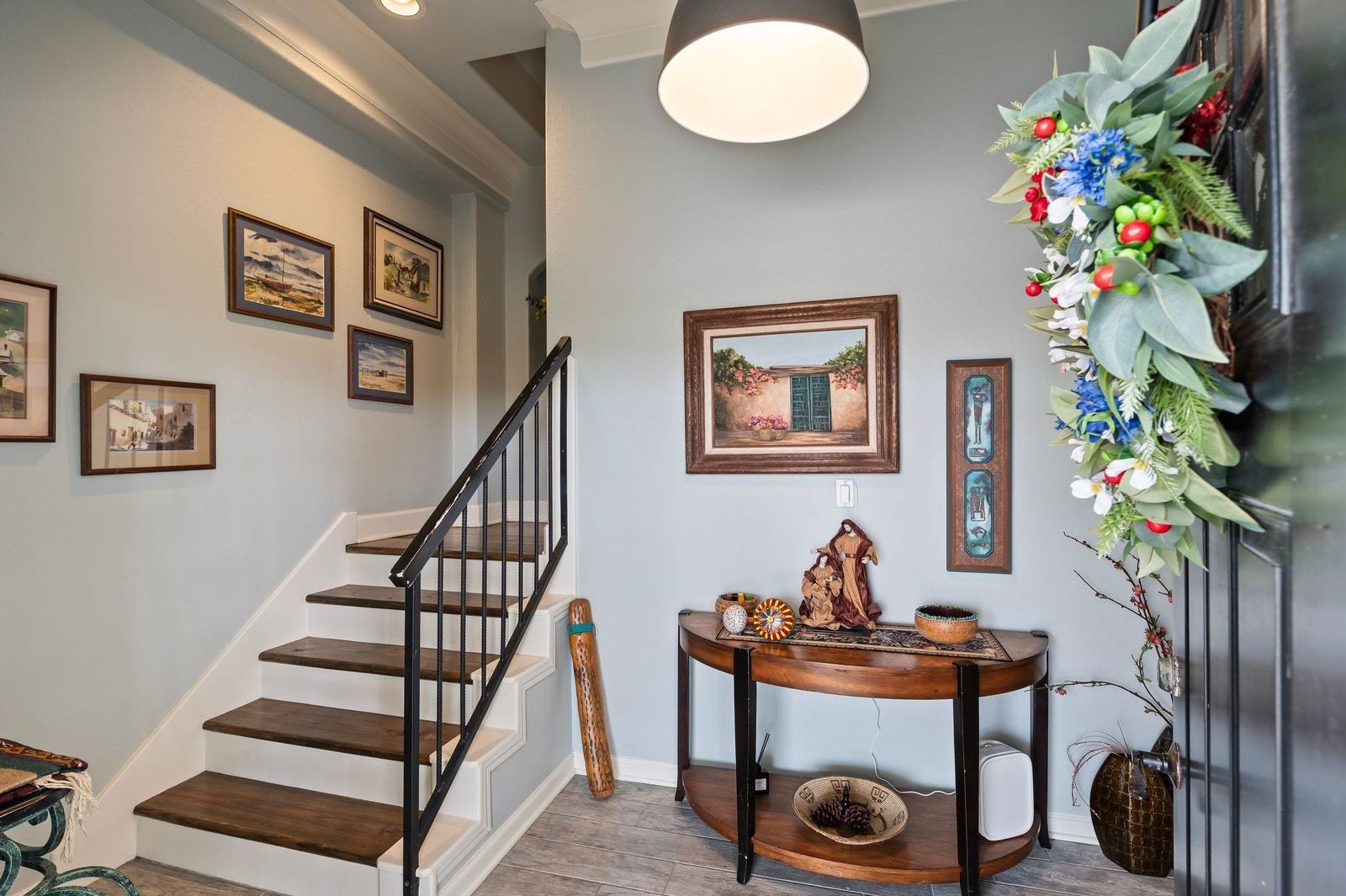 12 Tiki Circle, Tiki Island, TX 77554 Timeless Elegance & Ambiance! Upon entering at ground level, you're greeted with cool coastal colors and rich hardwood floors.