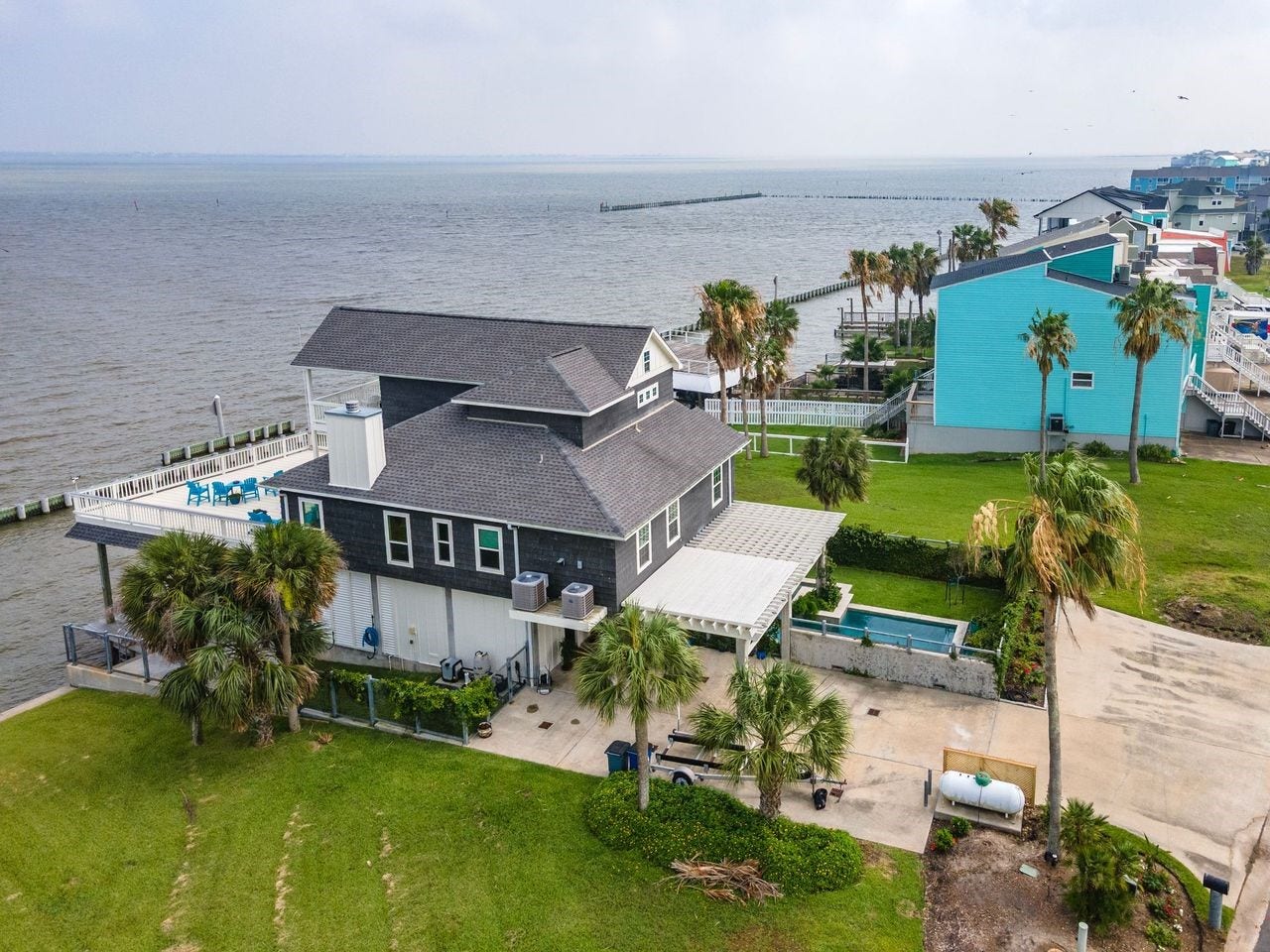 12 Tiki Circle, Tiki Island, TX 77554 Whether your passion is kayaking, paddleboarding, boating, or casting a line just steps from your back deck, this home delivers the waterfront lifestyle you've been dreaming of.