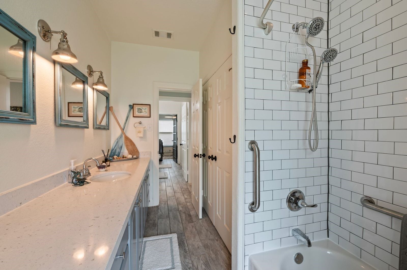 12 Tiki Circle, Tiki Island, TX 77554 Meticulously Renovated! Full secondary bathroom features custom fixtures, counters and subway tile surrounding the shower/tub combination.