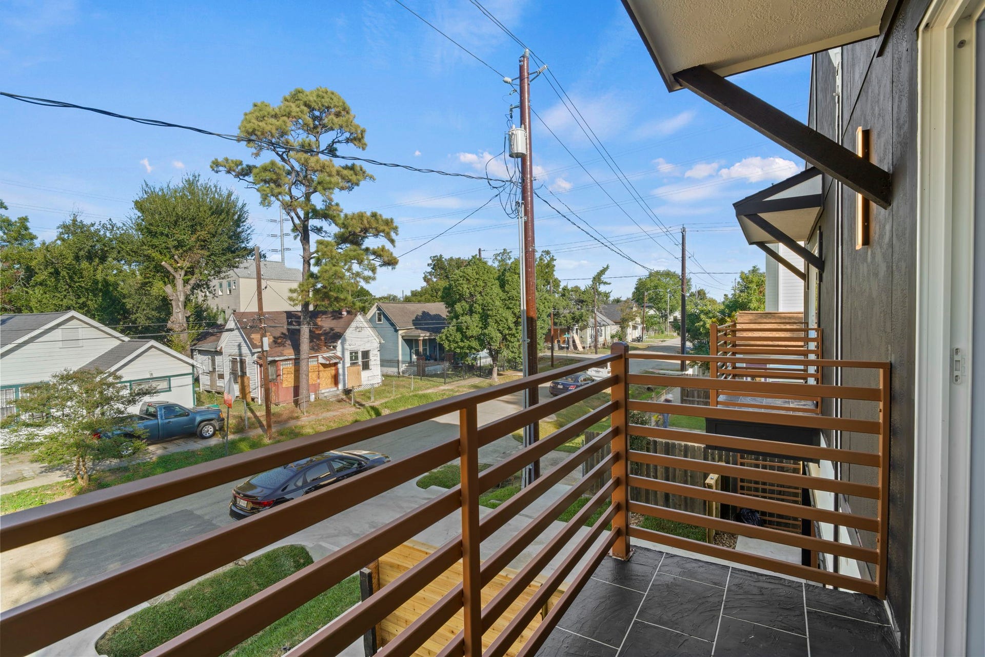Extending directly from the upper level, this balcony space combines functional design with outdoor relaxation.