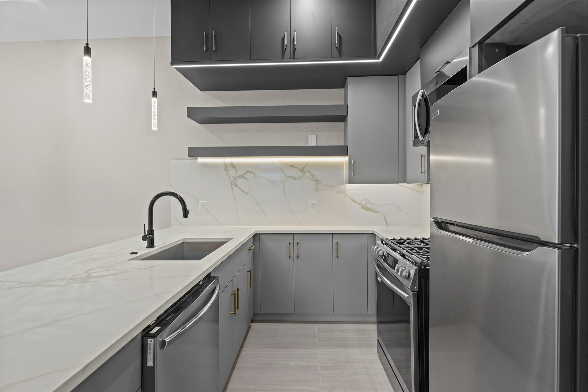 Virtually Staged: Sleek hardware, integrated appliances, and clean countertop surface area complete this refined, space-efficient design.