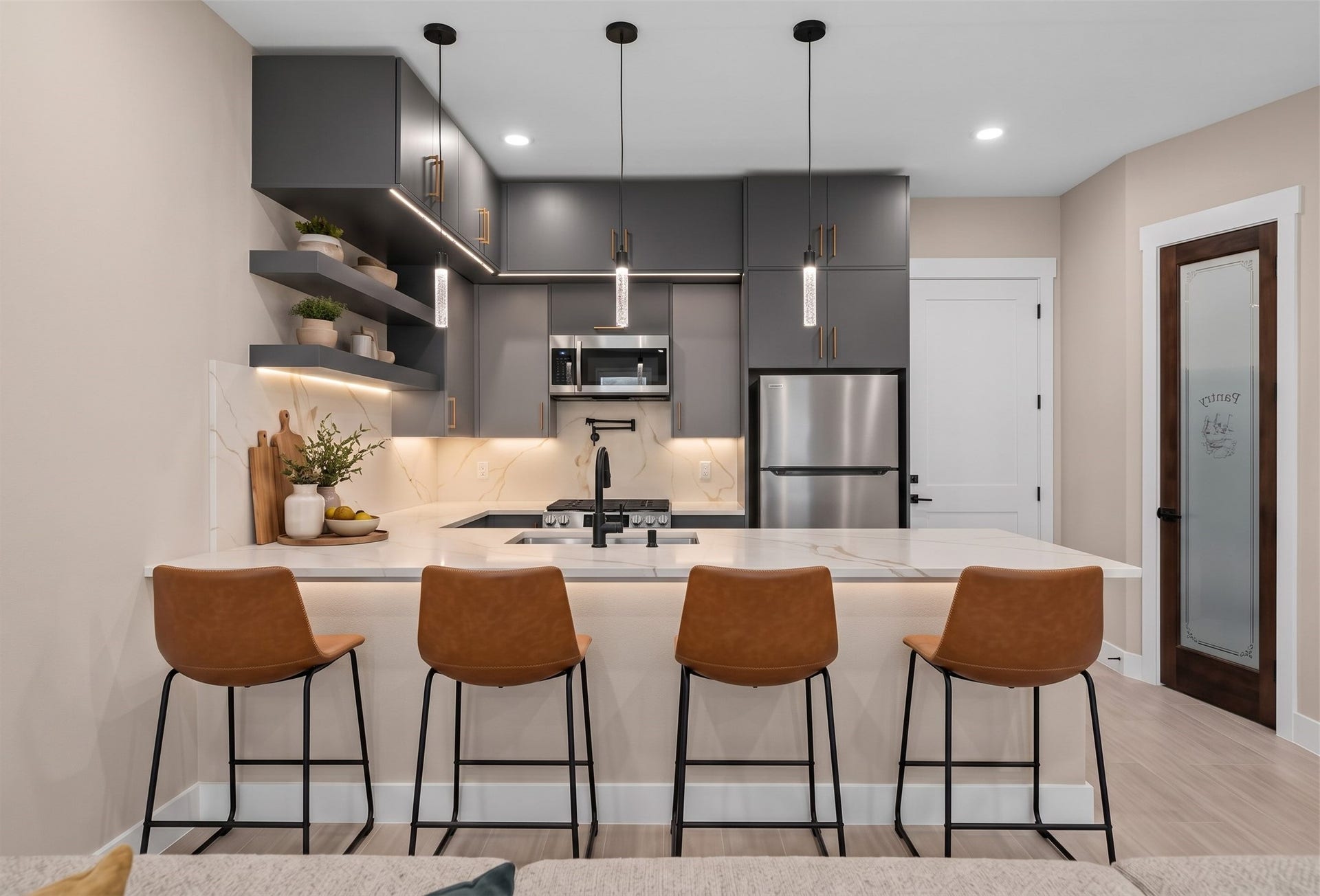 Virtually Staged: Designed for both daily living and hosting, this open kitchen features double-stacked upper cabinets for optimized storage space alongside a large functional island.