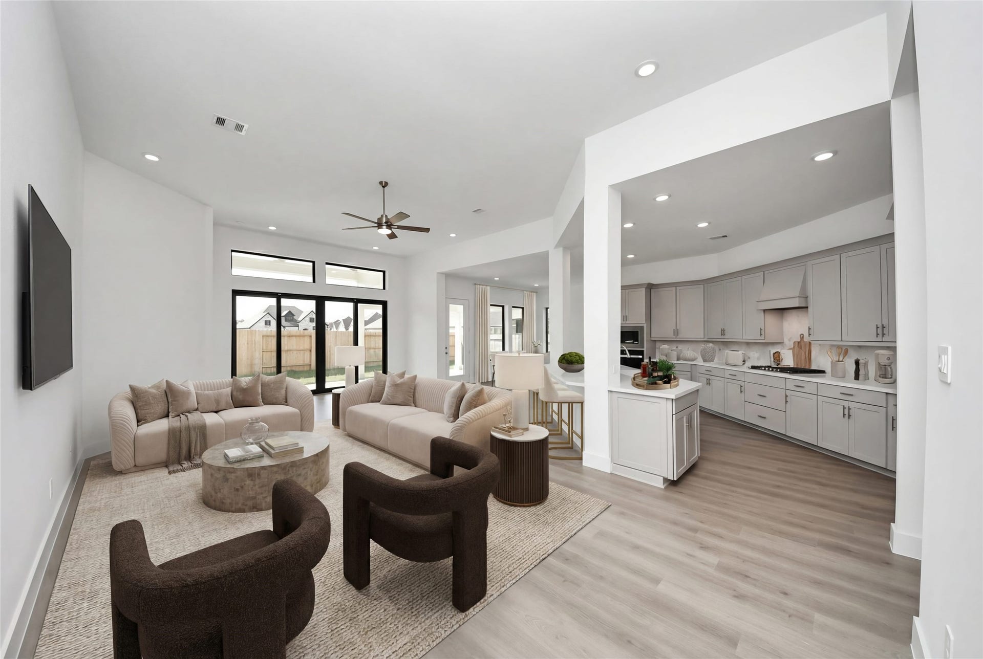 Walking into this expansive open-concept space, one immediately feels a sense of grandeur and tranquility thanks to the soaring ceilings and an abundance of natural light streaming through the massive glass slider.