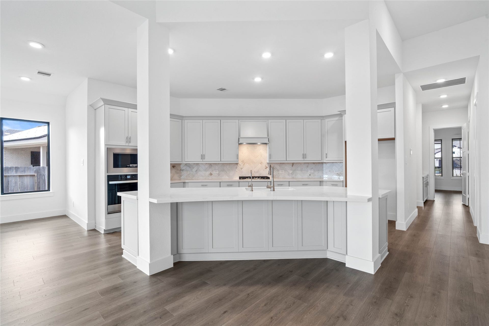 Grand view of this stunning gourmet kitchen which serves as the true heart of the home. Its open-concept layout seamlessly connects to the living spaces for effortless entertaining.