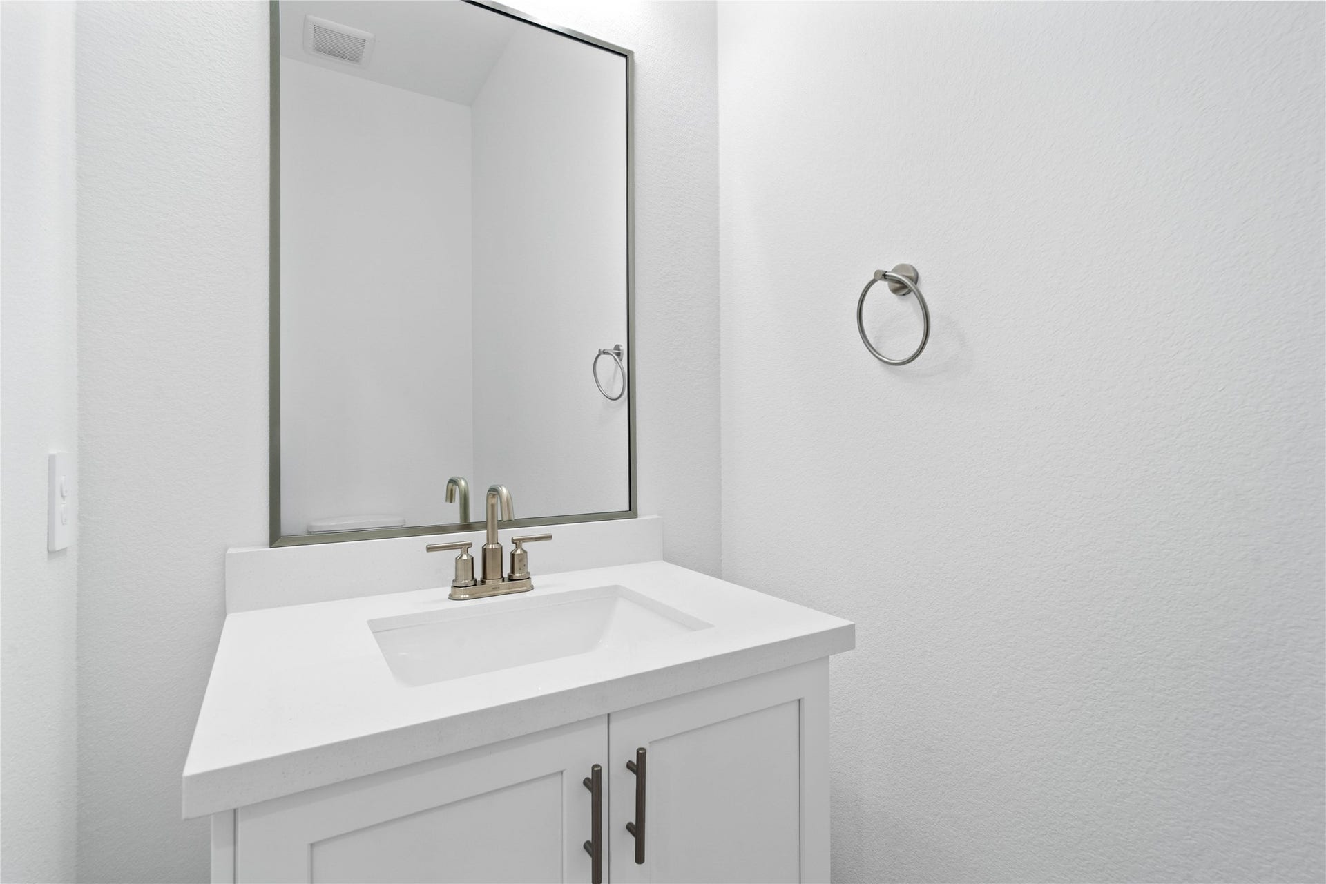 The powder bath features a stylish vanity and a clean, modern design.