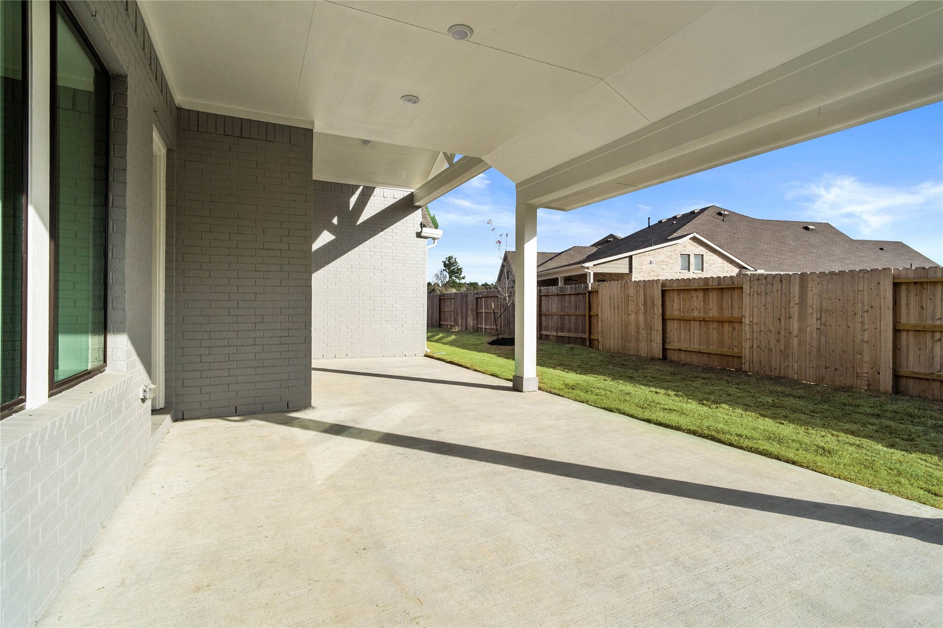 Step outside to the covered rear patio, the perfect extension of your indoor living space for year-round enjoyment.