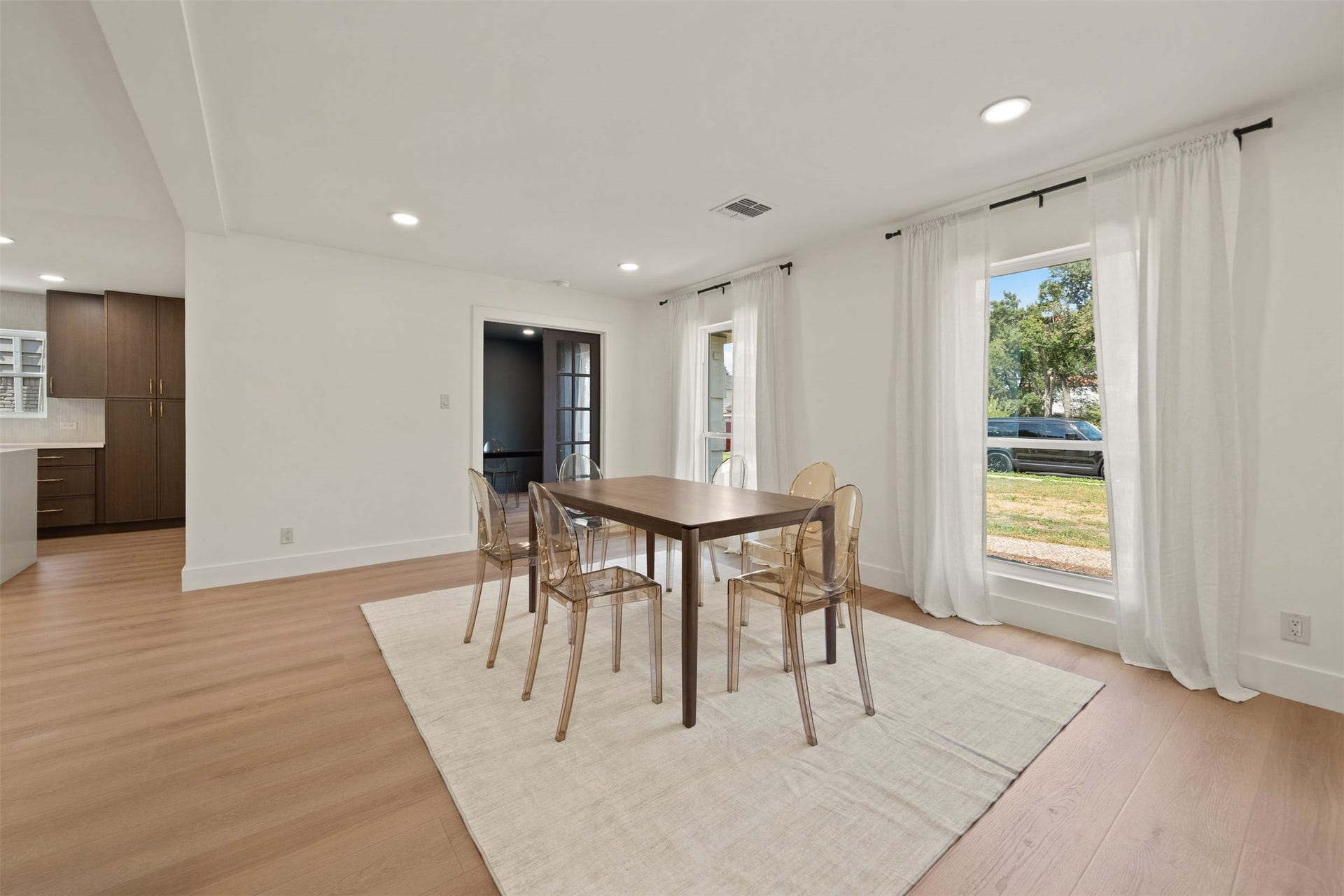 10111 Kerrwood Lane, Houston, TX 77080 The dining area features expansive windows that fill the space with abundant natural light, creating a bright and inviting atmosphere.
