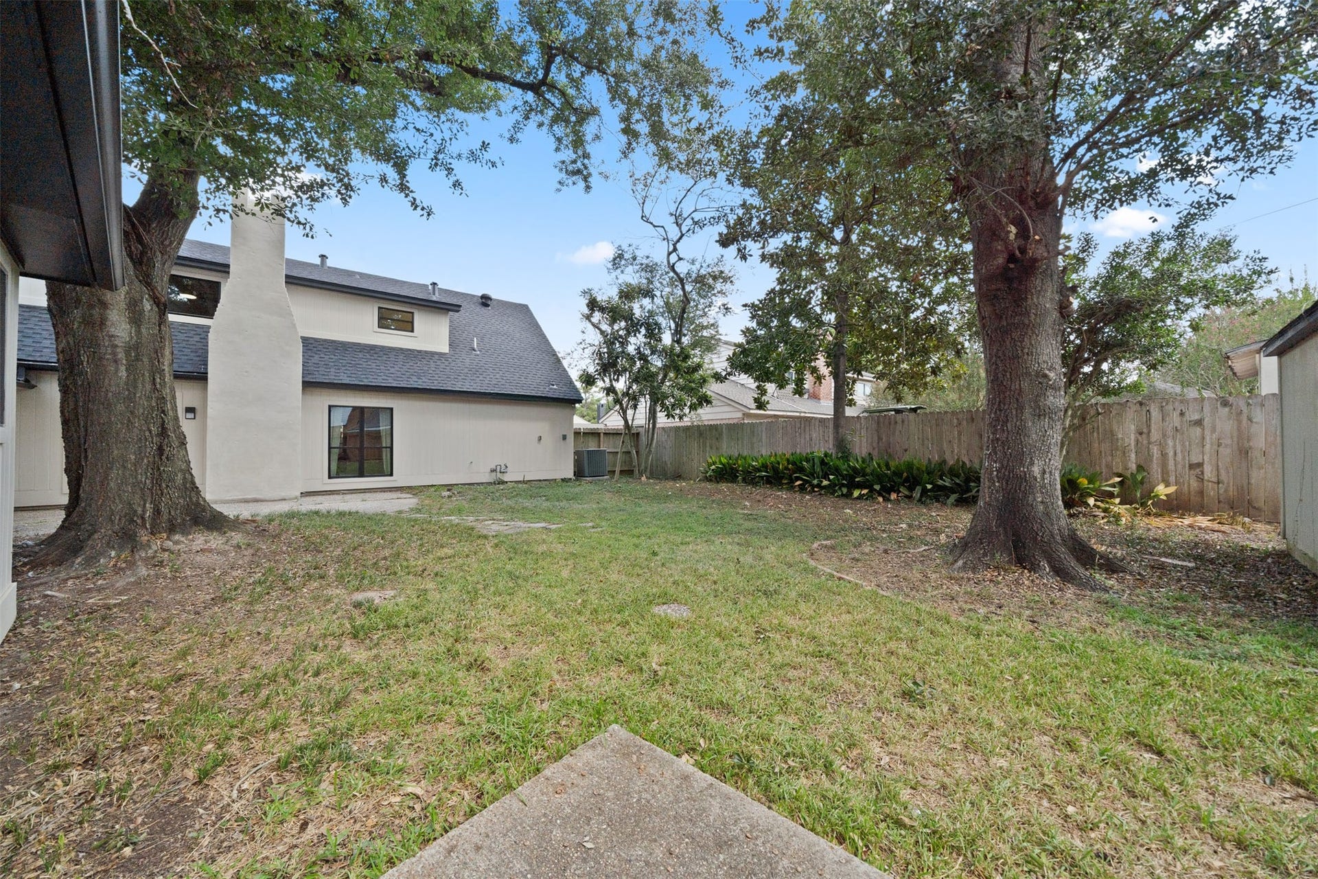 10111 Kerrwood Lane, Houston, TX 77080 The backyard features beautiful mature trees and ample space for outdoor entertaining, relaxing, and gathering with family and friends. Not pictured is an additional shed, offering even more space for organization and storage.