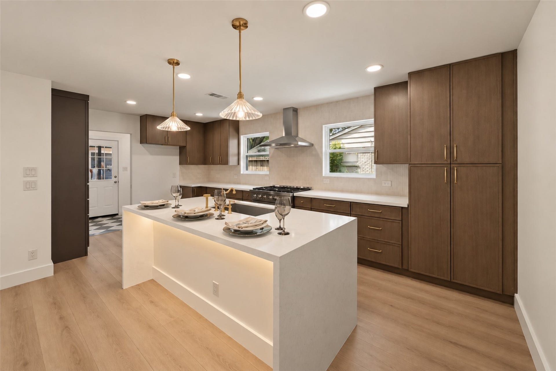 10111 Kerrwood Lane, Houston, TX 77080 Well-appointed kitchen features a stunning waterfall island, elegant cabinetry accented with brass hardware, and abundant drawer storage for effortless organization.